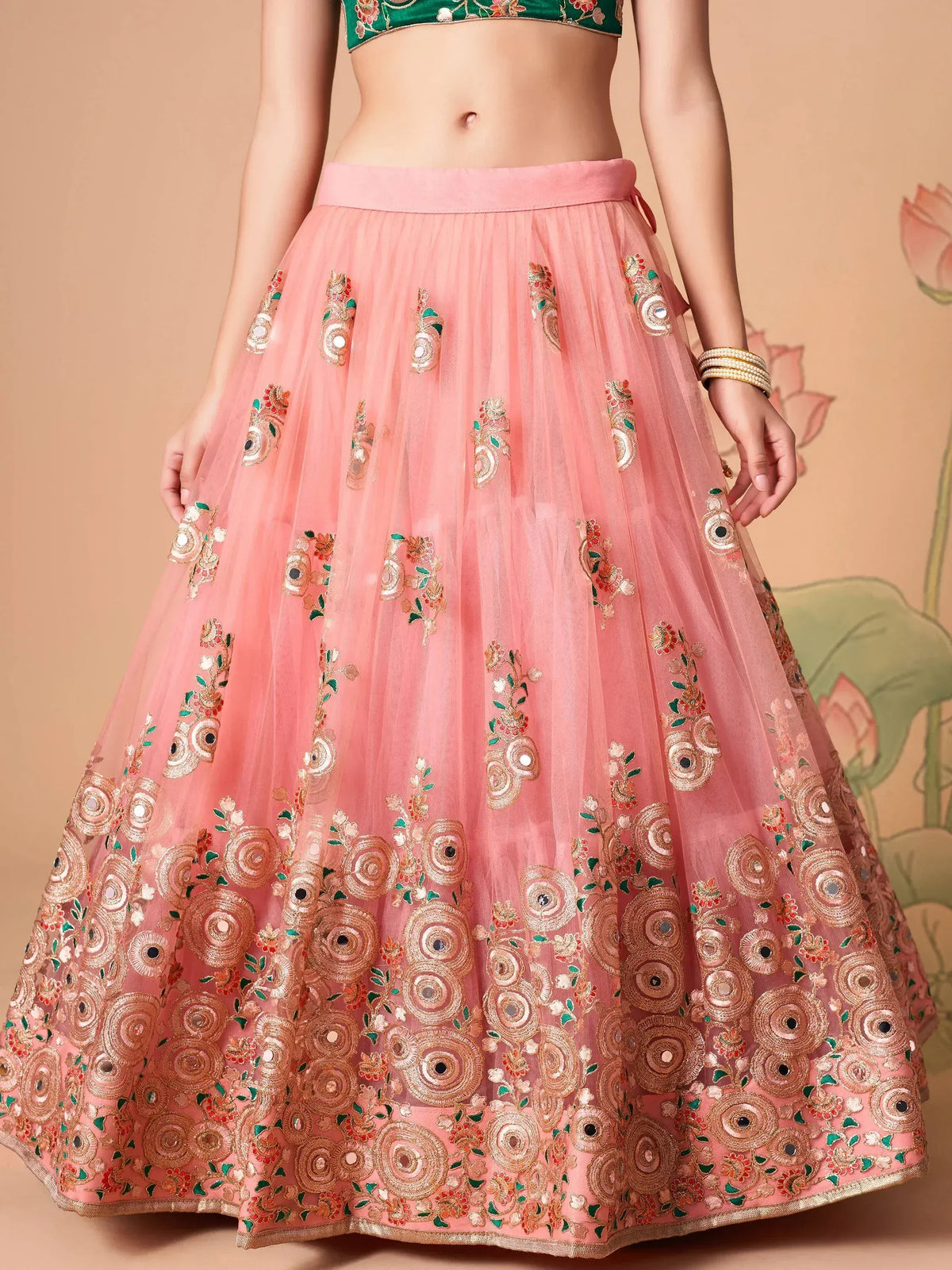 Pink embroidered lehenga skirt with floral motifs and mirror work, paired with green blouse for Indian ethnic wear