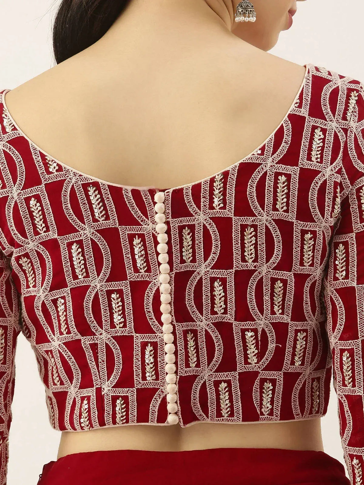 Red embroidered lehenga choli blouse with geometric pattern and pearl buttons, ethnic Indian wear
