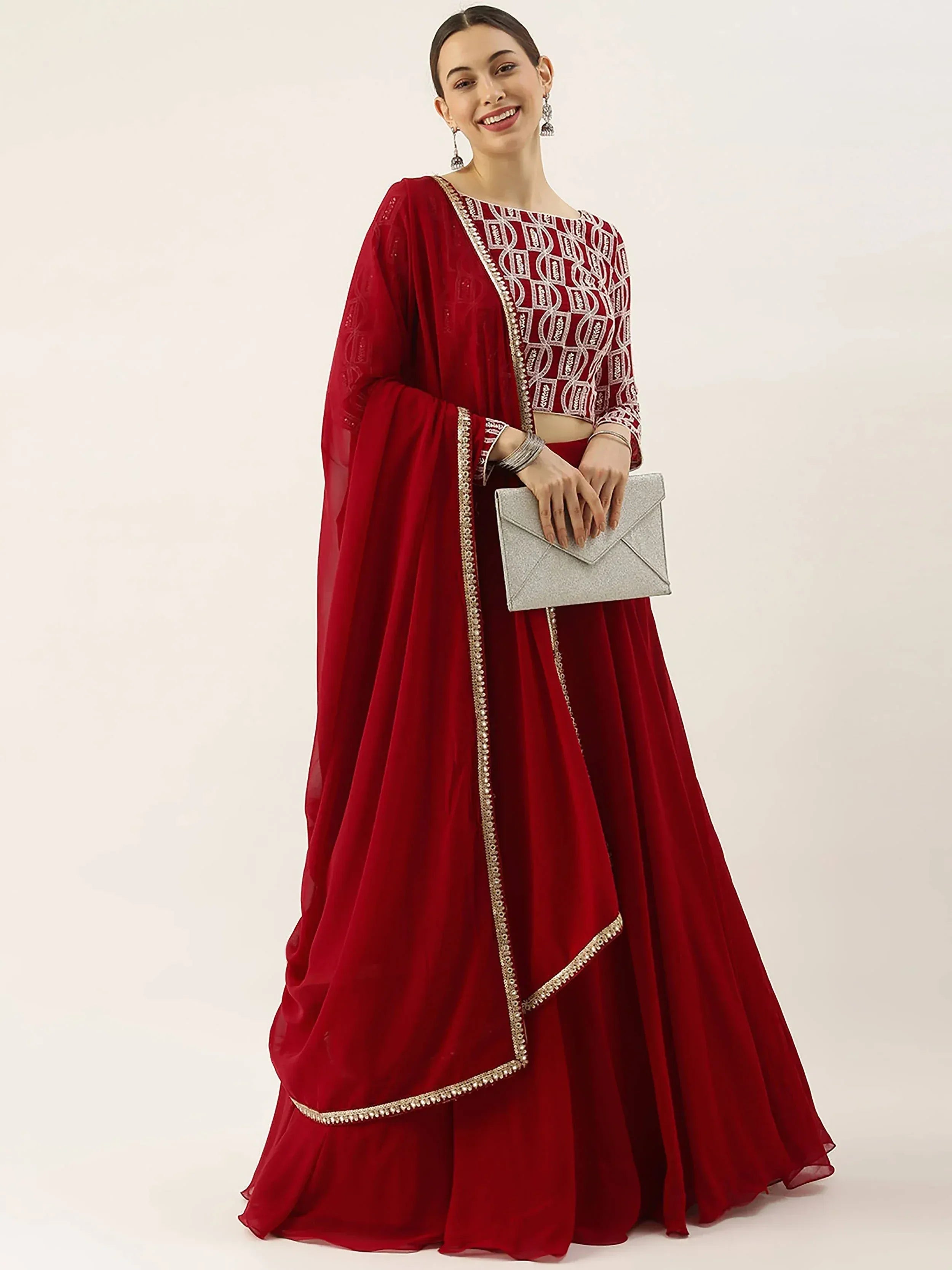 Red embroidered lehenga choli with sheer dupatta, perfect for Indian weddings and festive occasions.