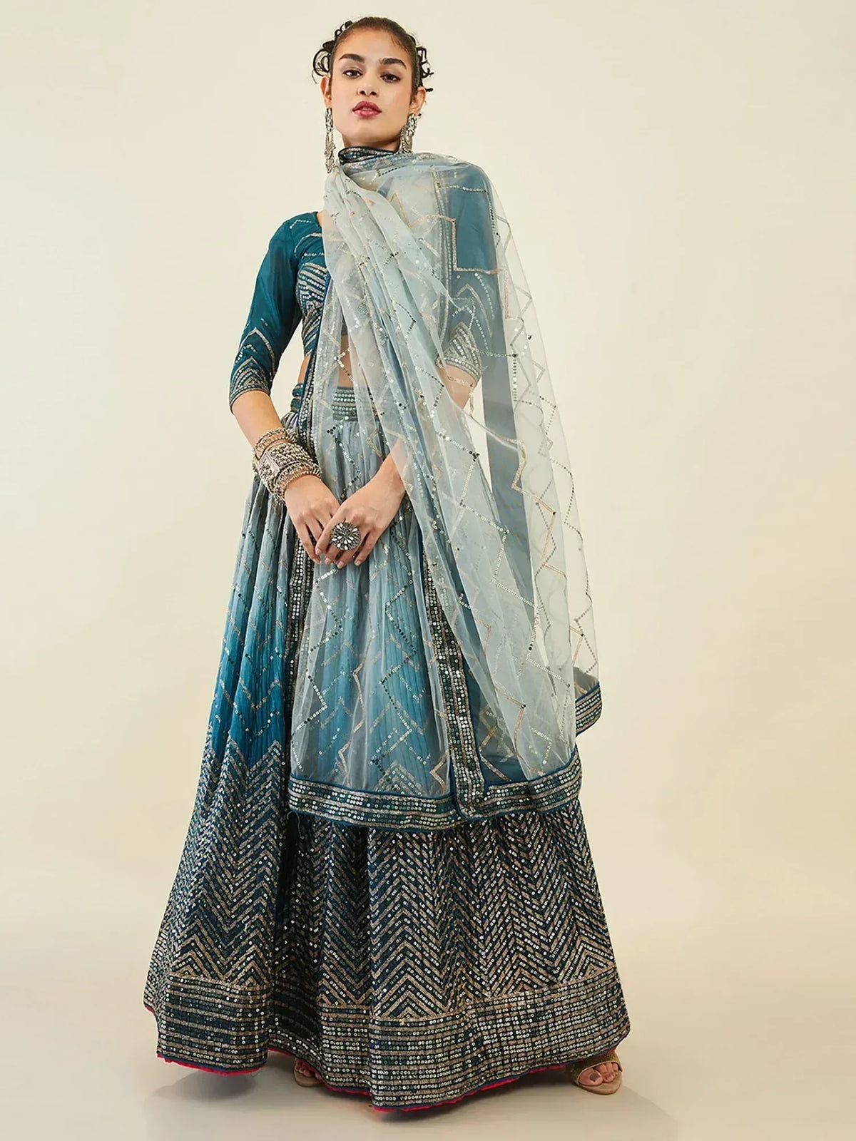 Elegant blue lehenga choli with geometric embroidery and sheer dupatta for Indian ethnic wear
