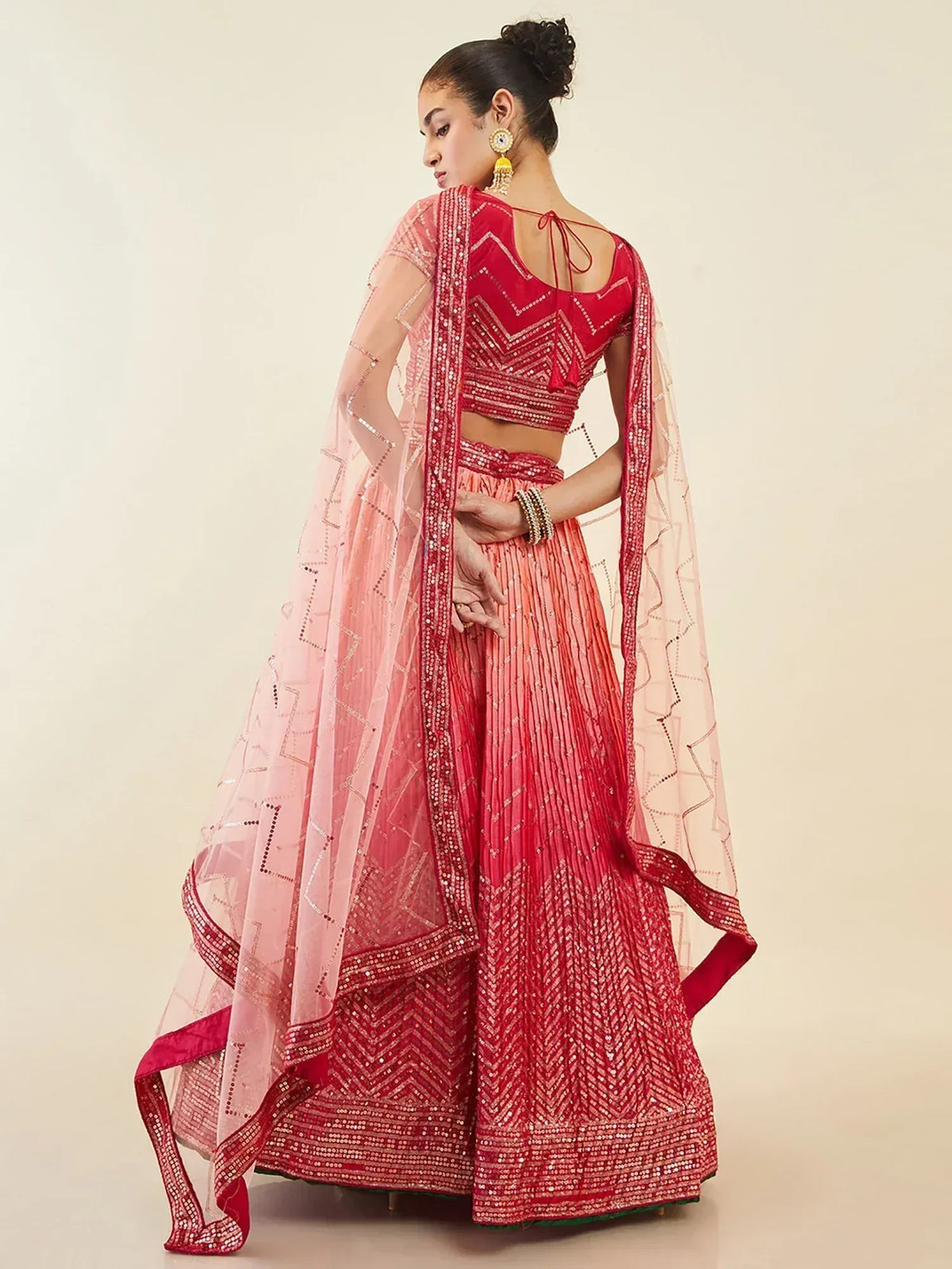 Red and pink embroidered lehenga choli with sheer dupatta, perfect for Indian ethnic wear
