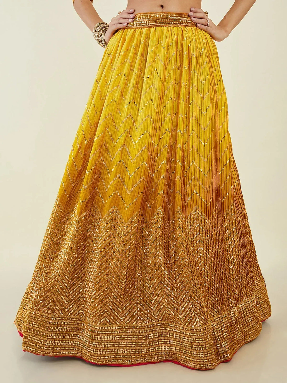 Yellow pleated lehenga skirt with gold chevron sequin embroidery, perfect for Indian ethnic wear