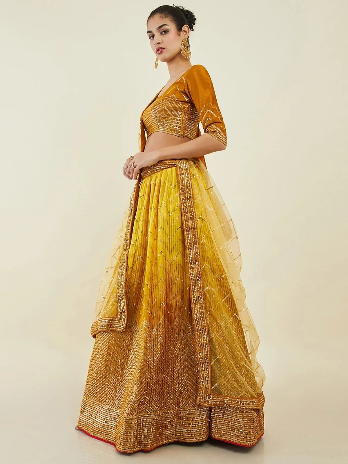 Golden embroidered lehenga choli with chevron pattern, perfect for Indian ethnic wear occasions