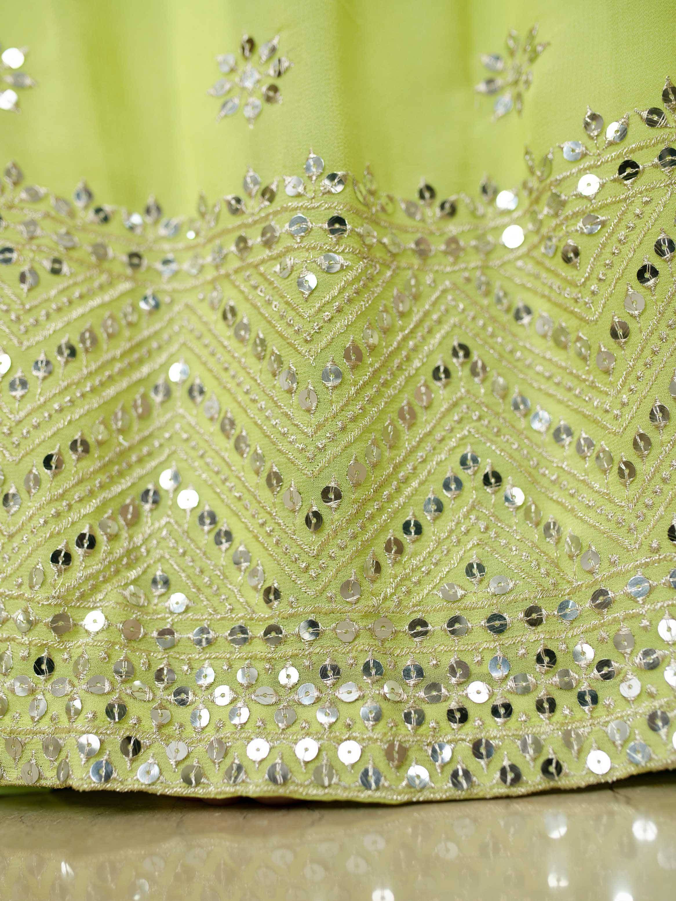 Lime green ethnic wear with intricate silver sequin and thread embroidery detailing.