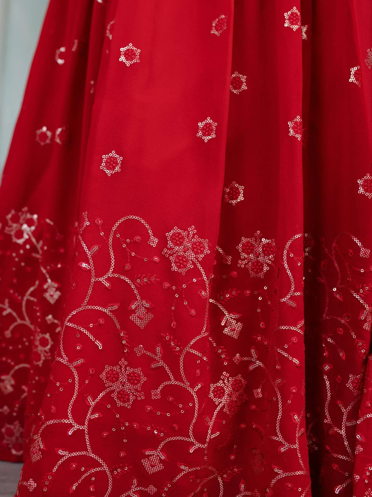 Red ethnic lehenga with intricate floral sequin embroidery, perfect for Indian weddings and festive occasions.