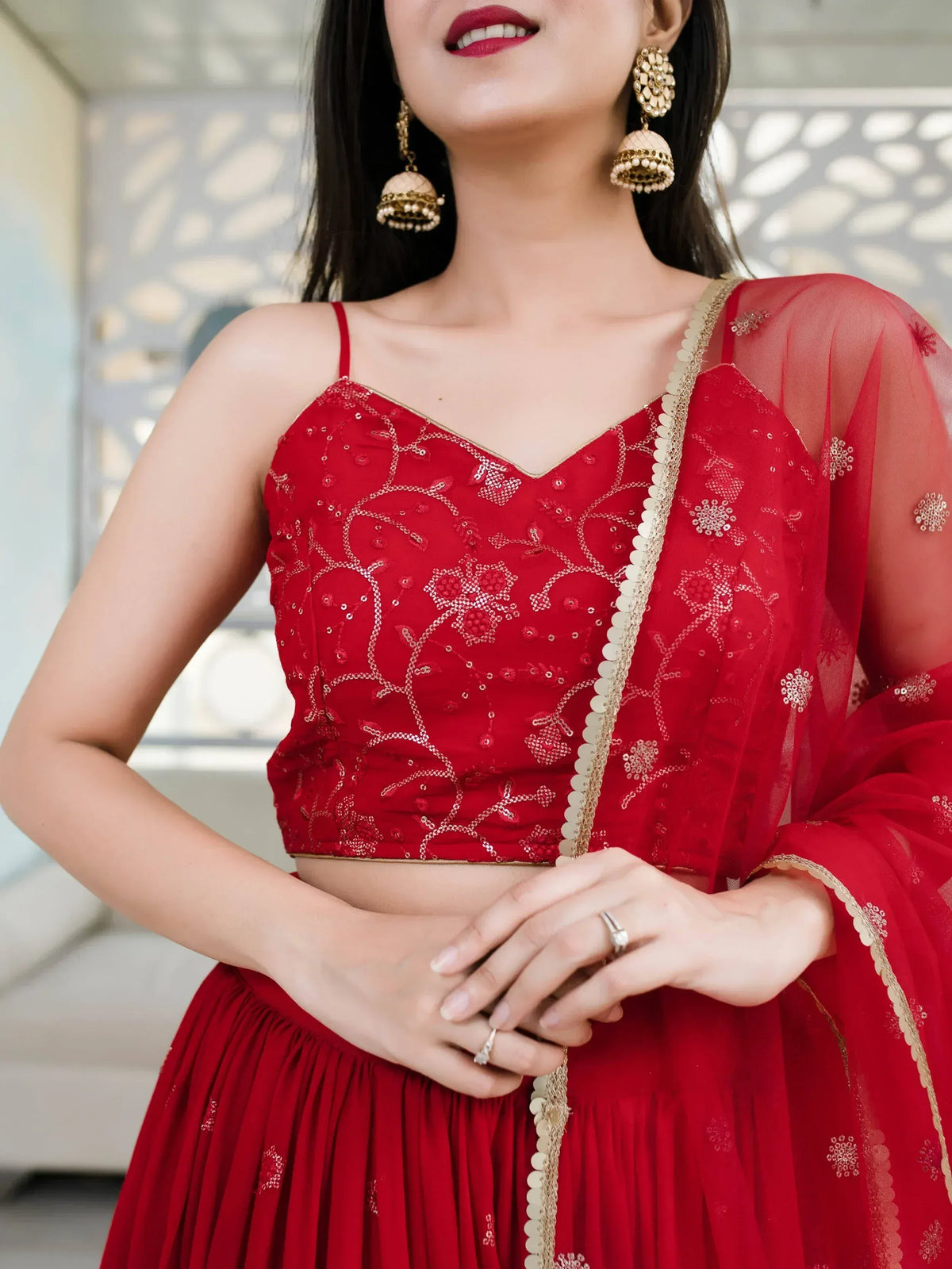 Red embroidered lehenga choli with gold detailing and sheer dupatta, perfect for Indian ethnic wear occasions