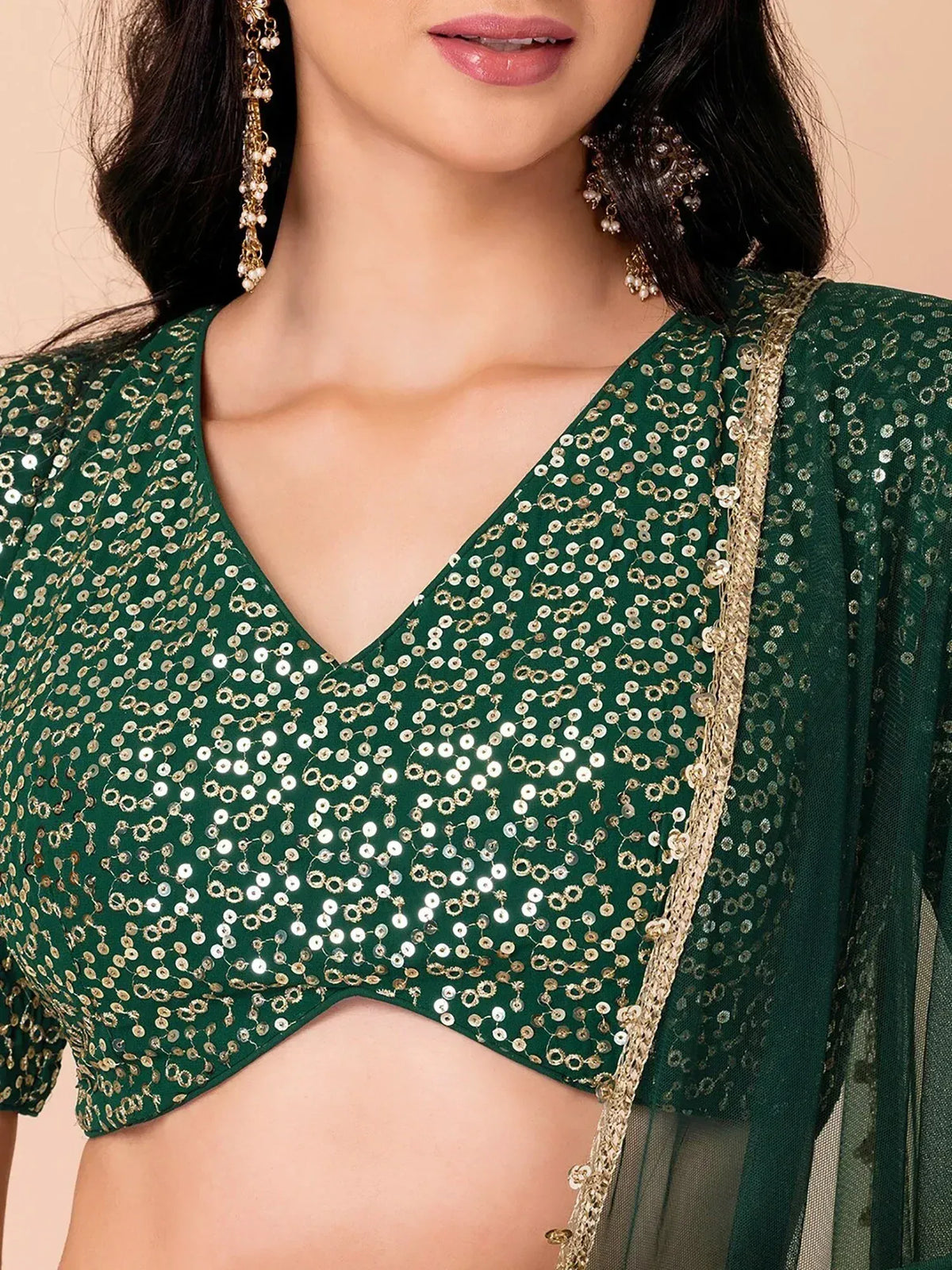 Emerald green sequin lehenga choli with gold trim and sheer dupatta, perfect for Indian ethnic wear