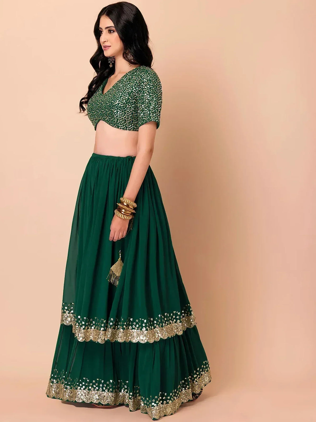 Emerald green lehenga choli with gold embroidery, perfect for Indian ethnic wear and festive occasions.