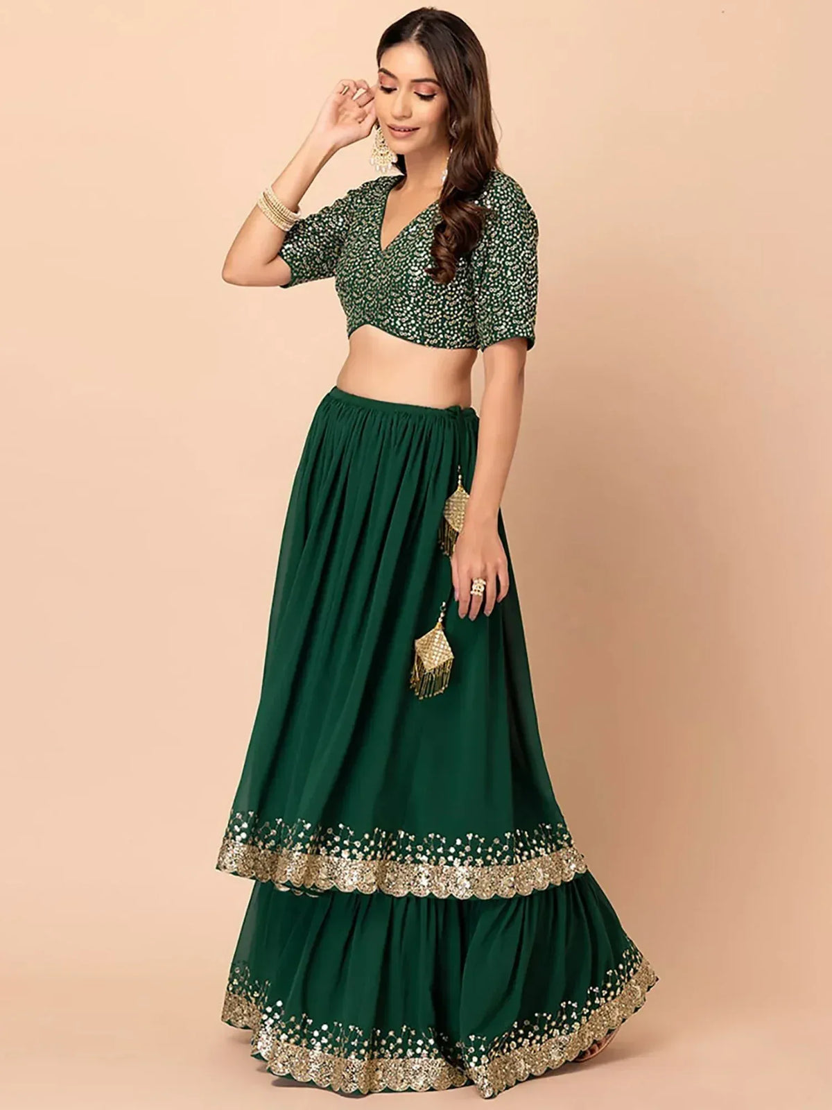 Emerald green lehenga choli with gold embroidery, perfect for Indian ethnic wear and festive occasions.
