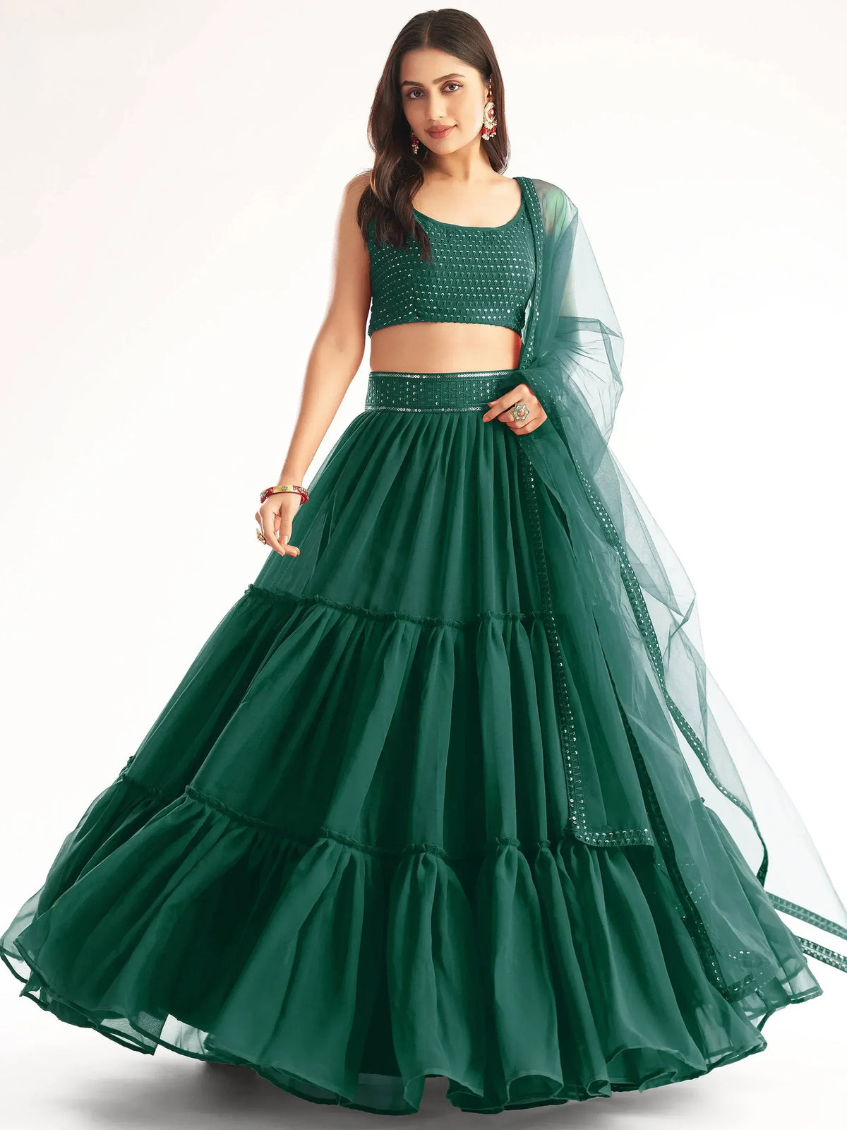 Emerald green designer lehenga choli with sequin embellishments and sheer dupatta, perfect for Indian ethnic wear.