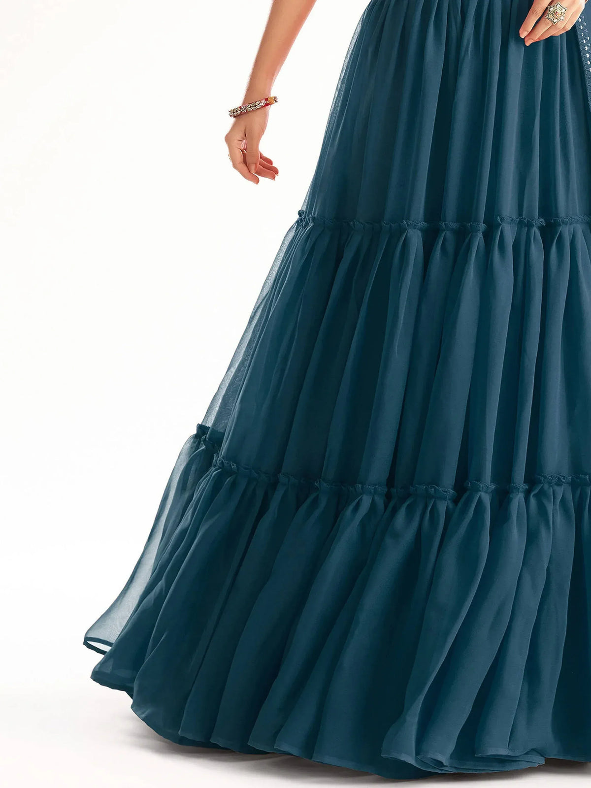 Teal tiered ethnic gown with ruffled layers and sheer fabric, perfect for Indian occasions
