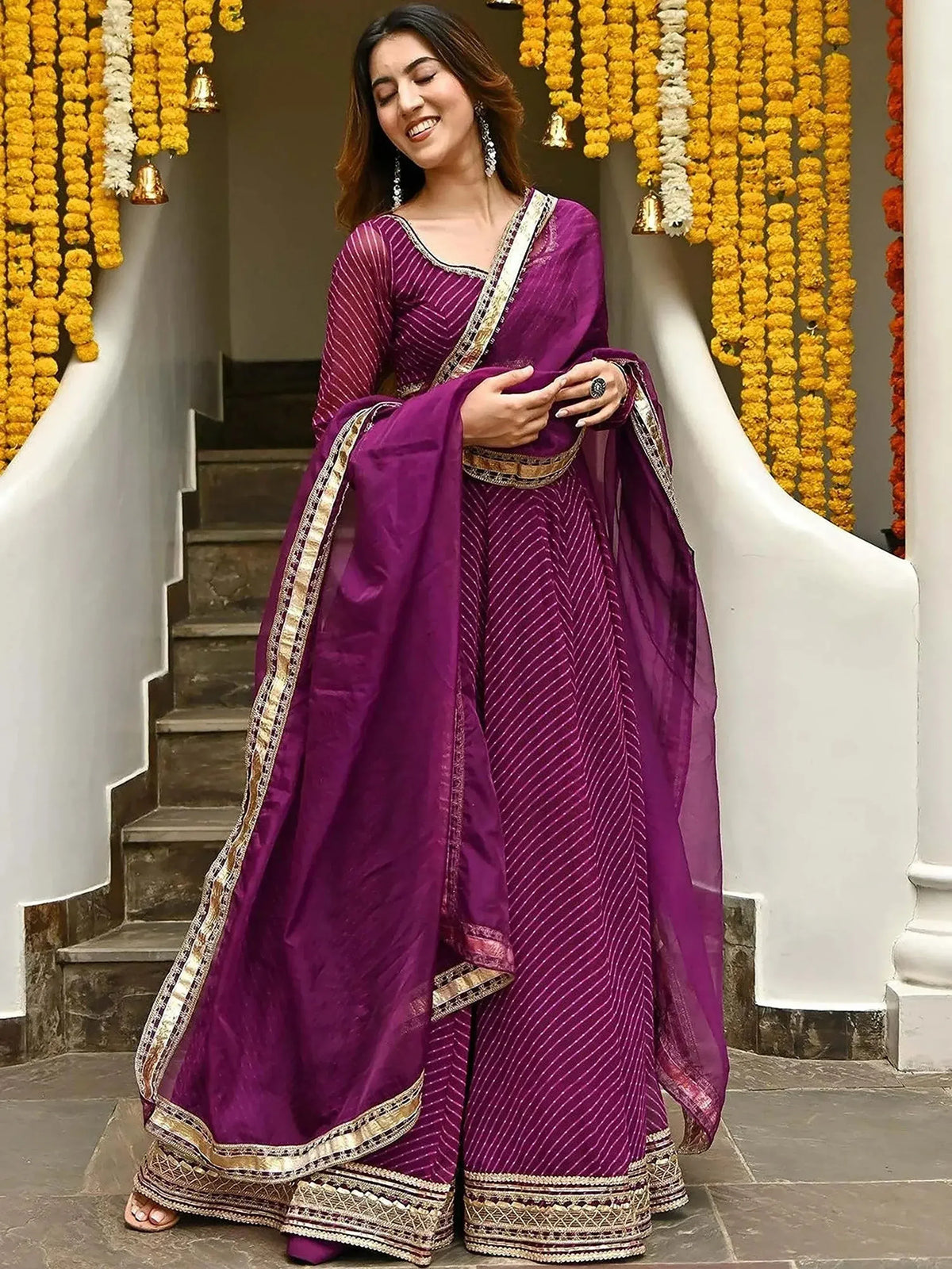 Purple ethnic gown with gold embroidery, perfect for festive occasions and celebrations.