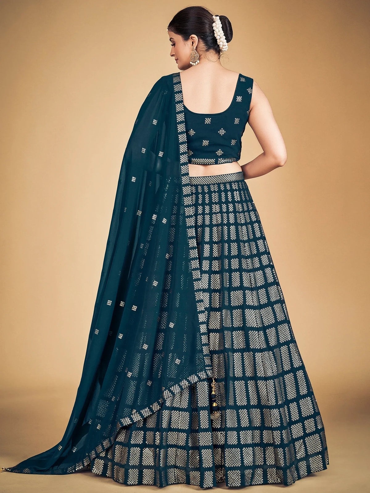 Teal designer lehenga choli with gold geometric patterns and matching dupatta