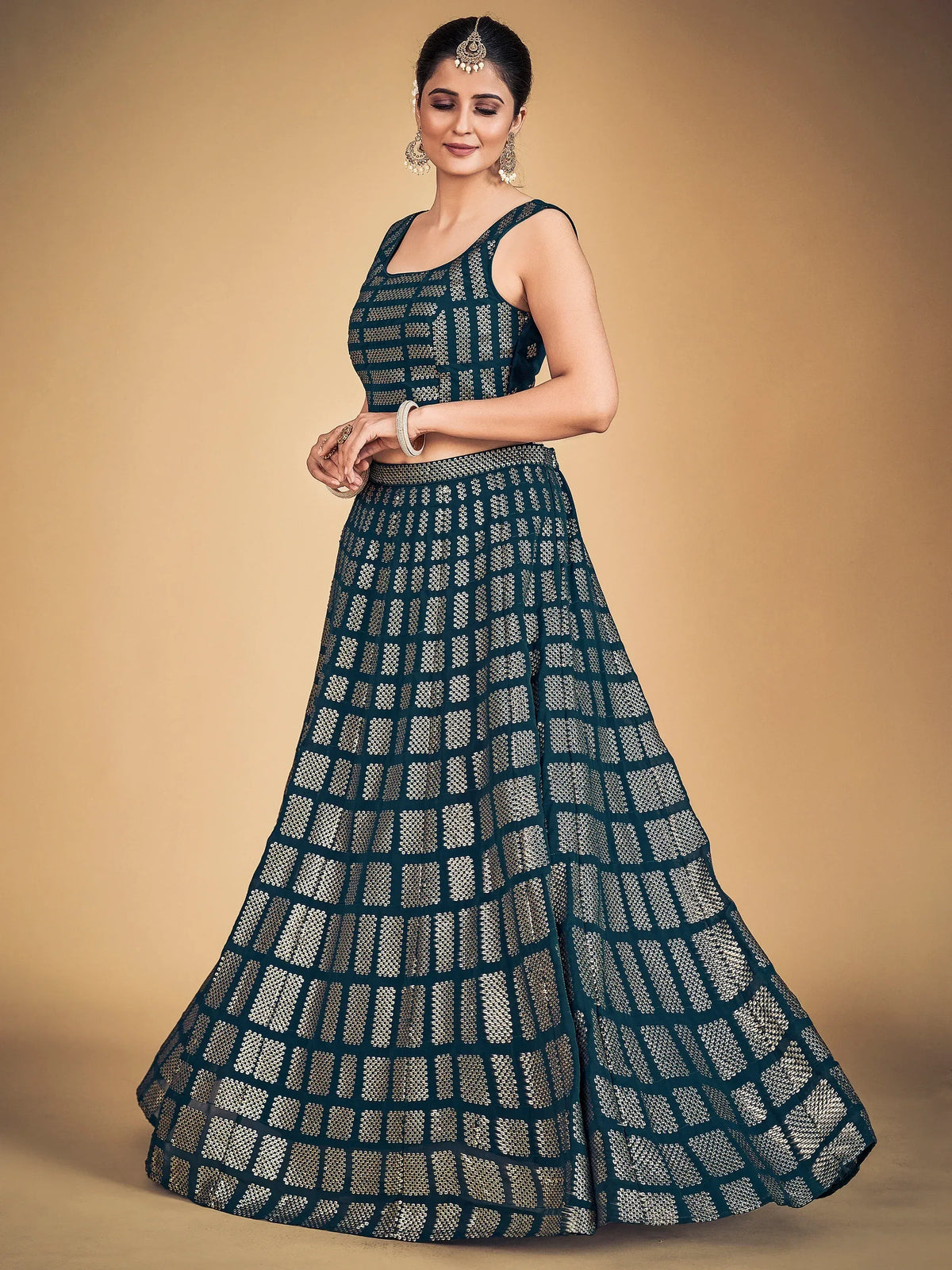 Elegant teal lehenga choli with gold geometric patterns, perfect for Indian ethnic wear