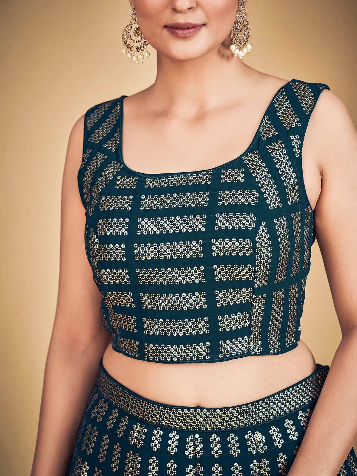 Teal embroidered crop top and skirt set with gold floral patterns, perfect for ethnic wear.
