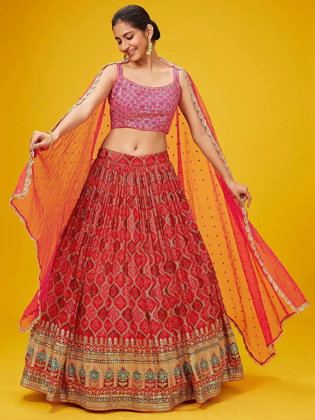 Red embroidered lehenga choli with gold detailing and orange dupatta for Indian ethnic wear
