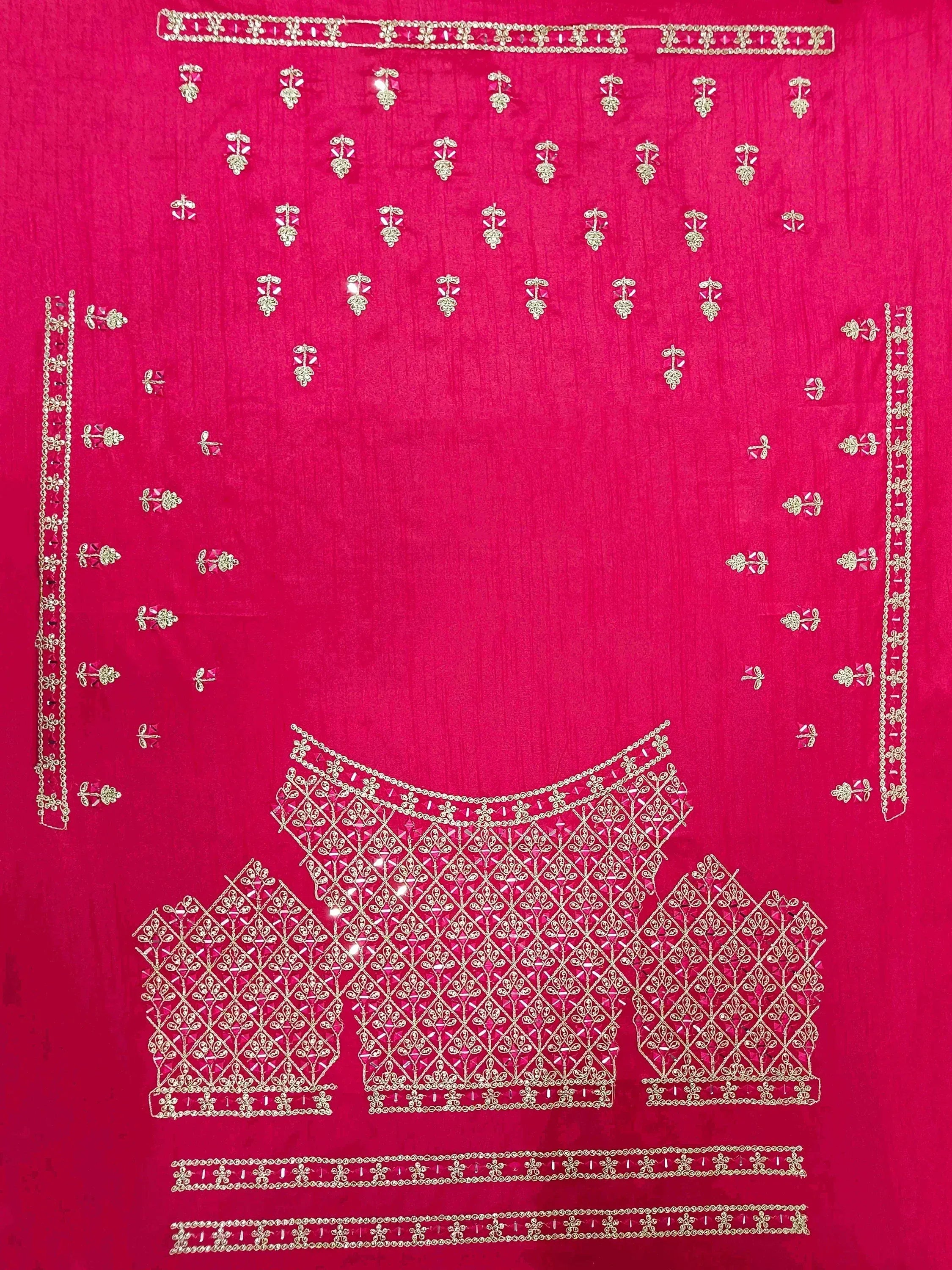 Fuchsia pink ethnic blouse with intricate gold embroidery and mirror work, perfect for Indian weddings or festive occasions.
