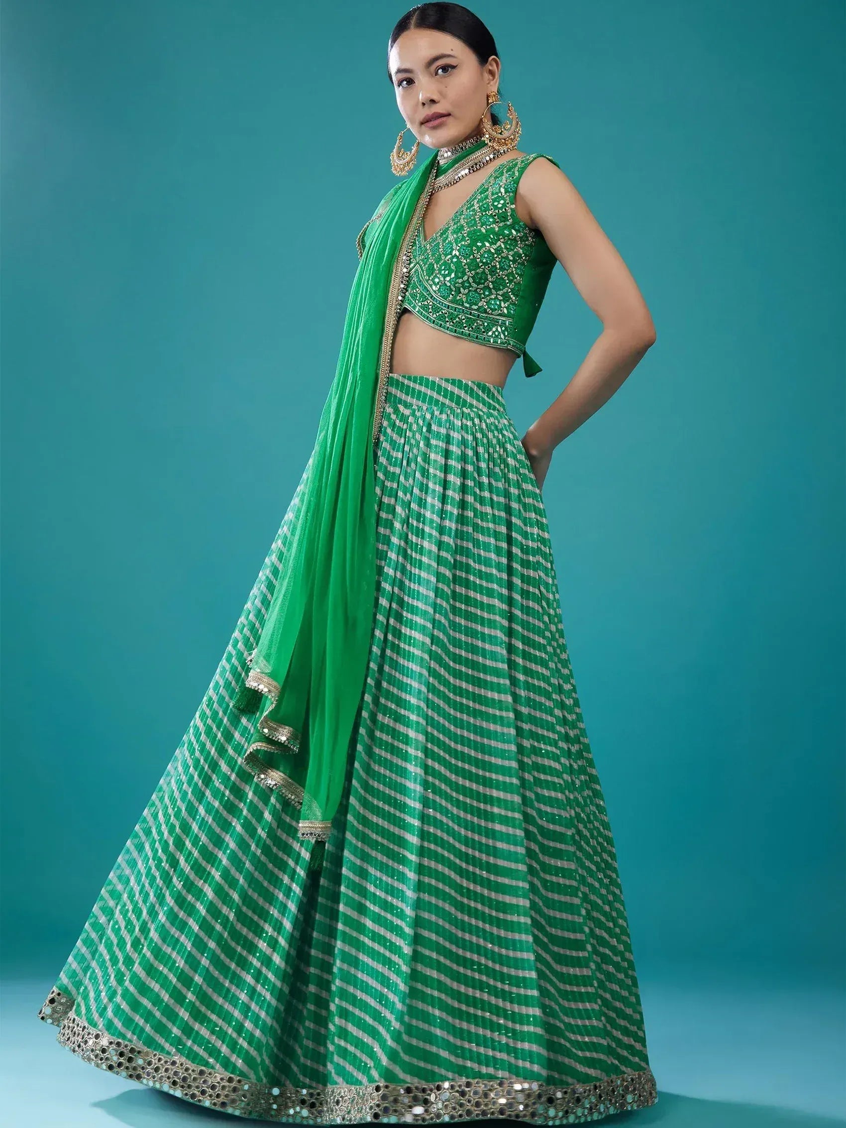 Emerald green lehenga choli with silver stripes and mirror work, perfect for Indian ethnic wear events