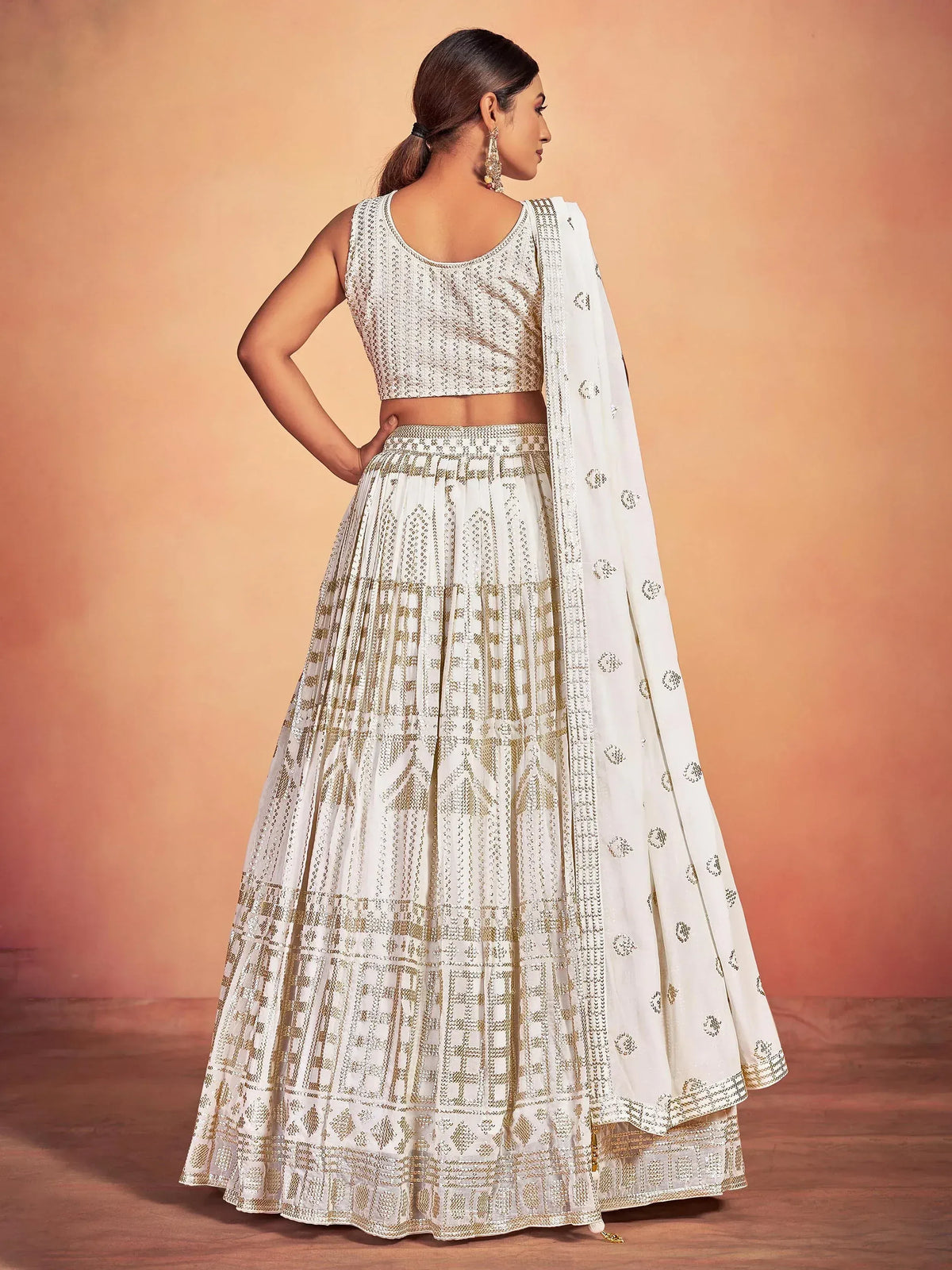 White and gold embroidered lehenga choli with dupatta, perfect for Indian ethnic wear occasions.