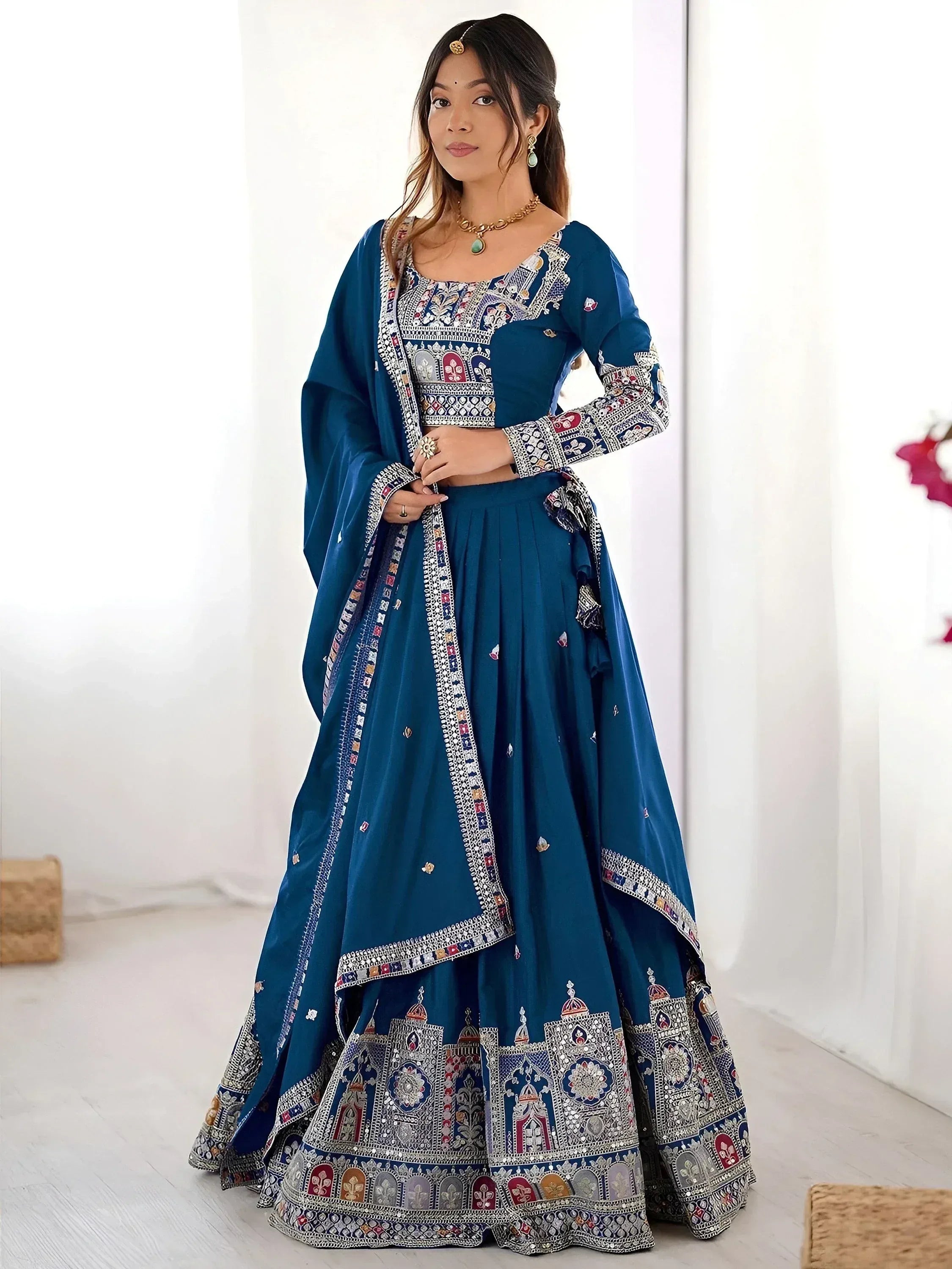 Blue embroidered lehenga choli with intricate mirror work and traditional Indian ethnic wear design