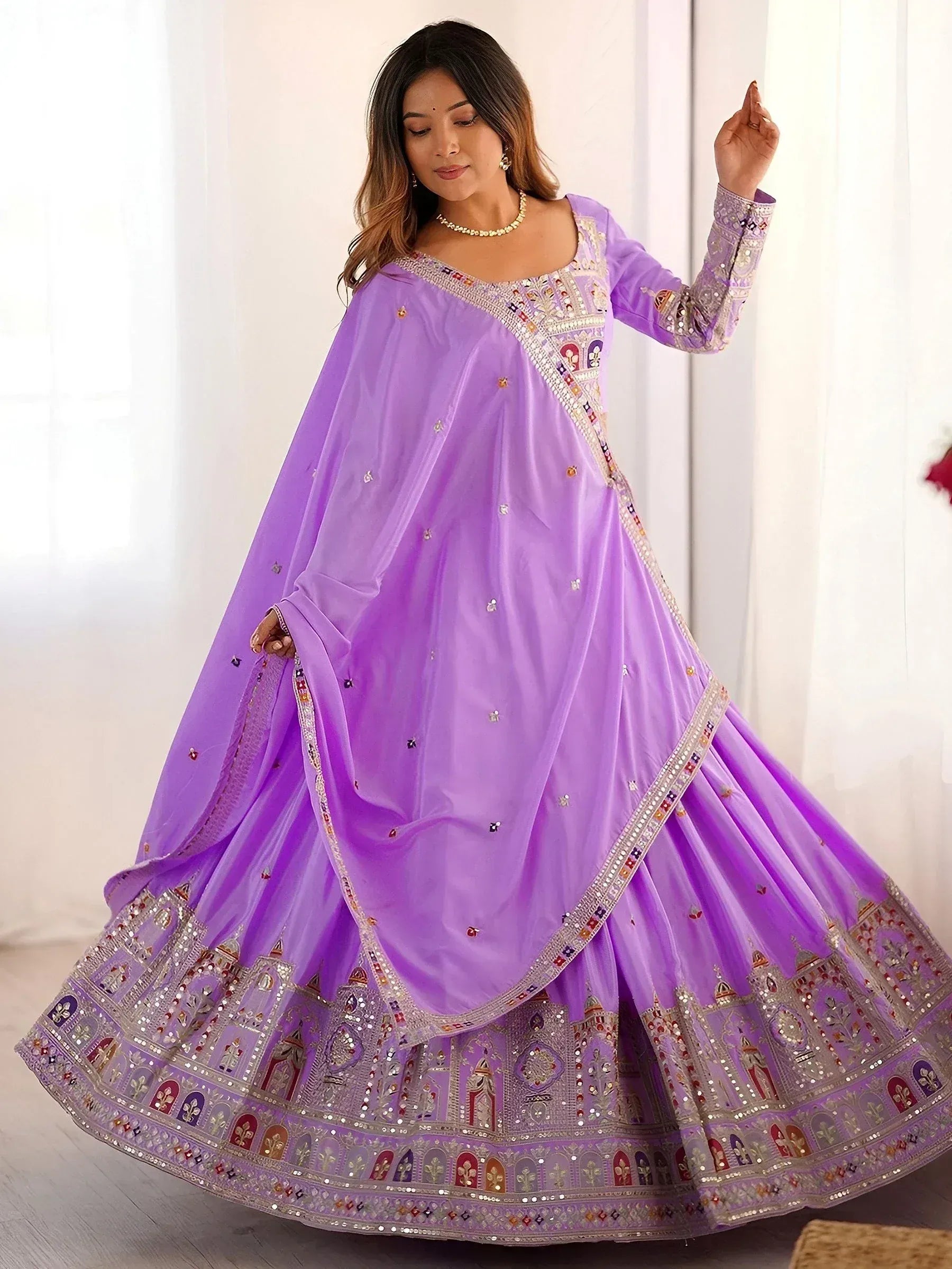 Lavender designer lehenga choli with intricate embroidery and mirror work, perfect for Indian ethnic occasions.