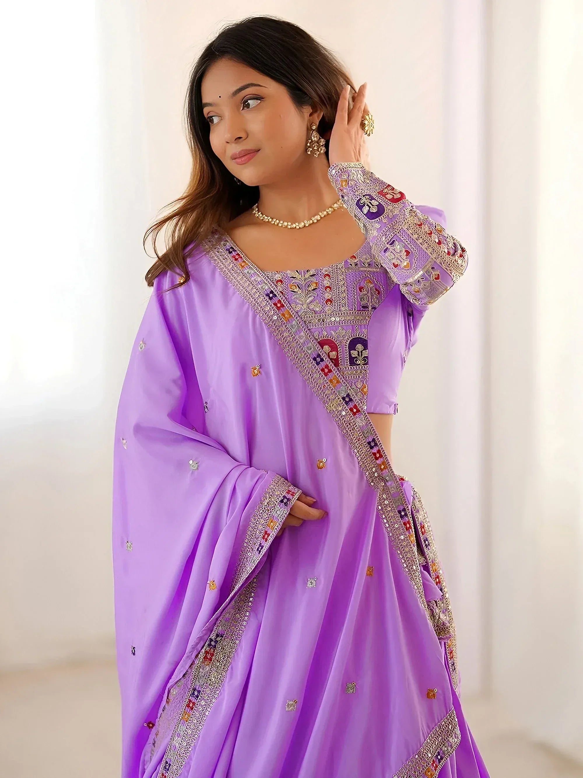 Purple embroidered Indian ethnic gown with detailed neckline and sleeve work, perfect for festive occasions.