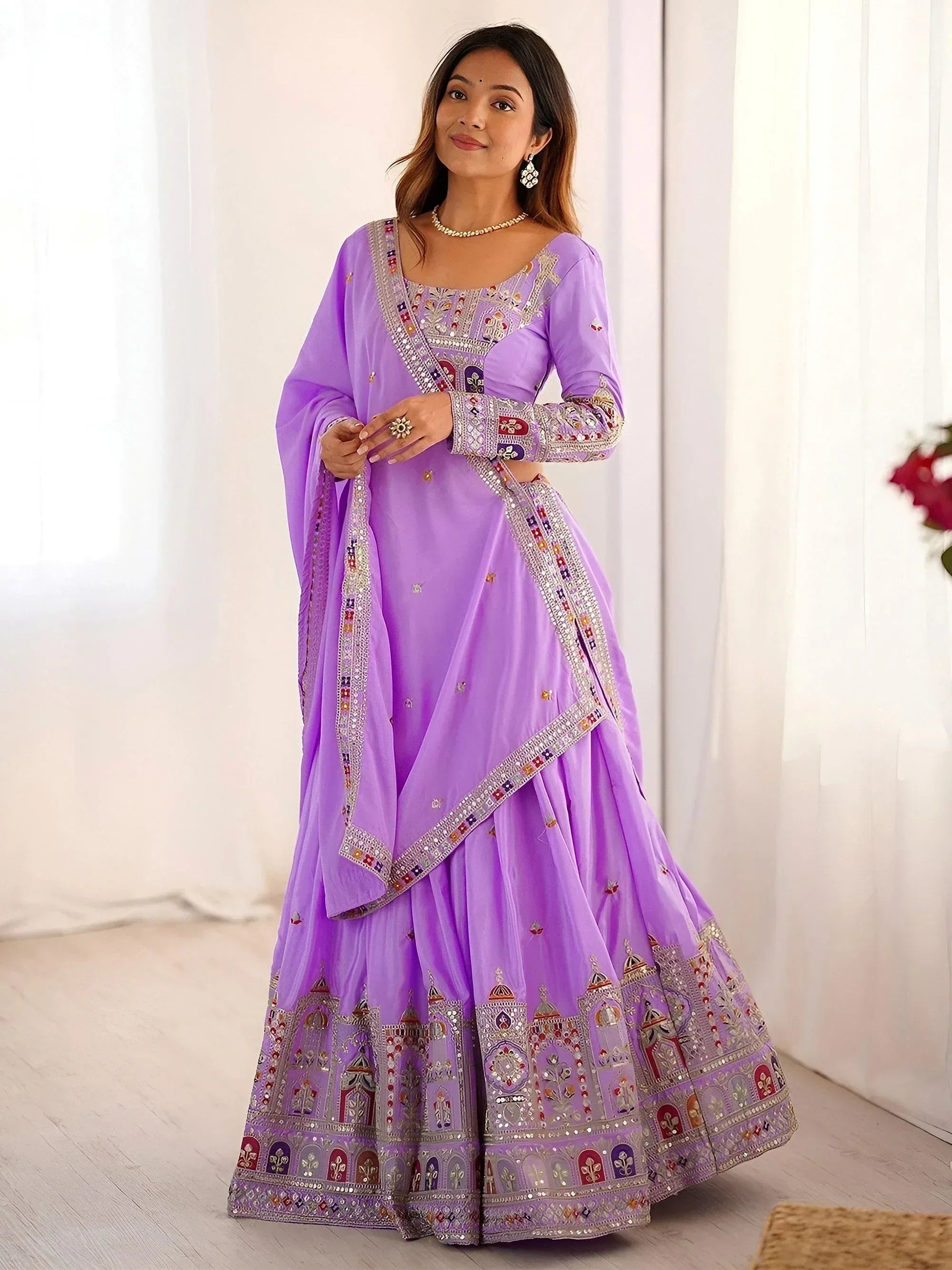 Lavender designer lehenga choli with intricate embroidery and mirror work, perfect for Indian ethnic occasions.