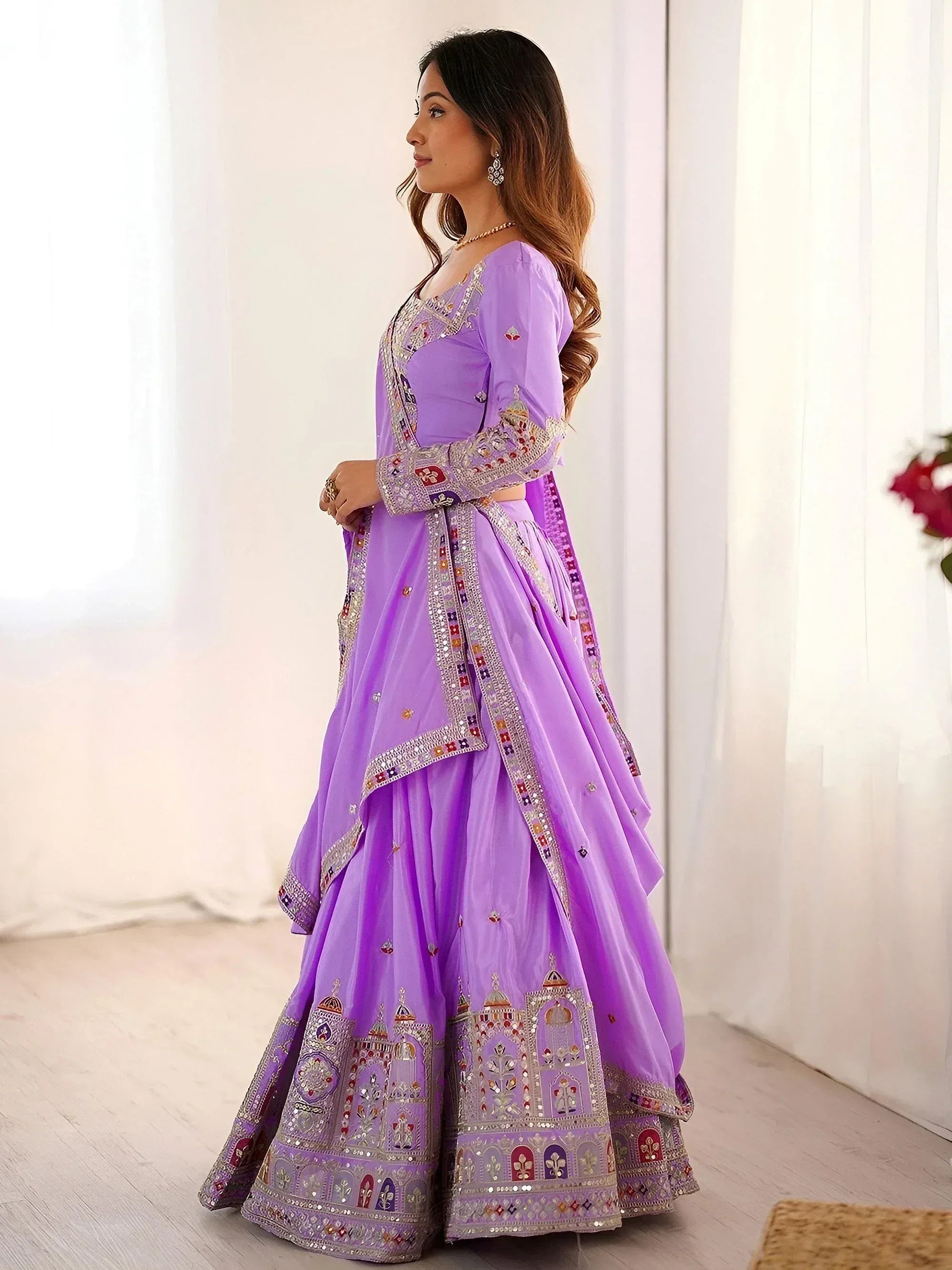 Lavender designer lehenga choli with intricate embroidery and mirror work, perfect for Indian ethnic wear occasions.