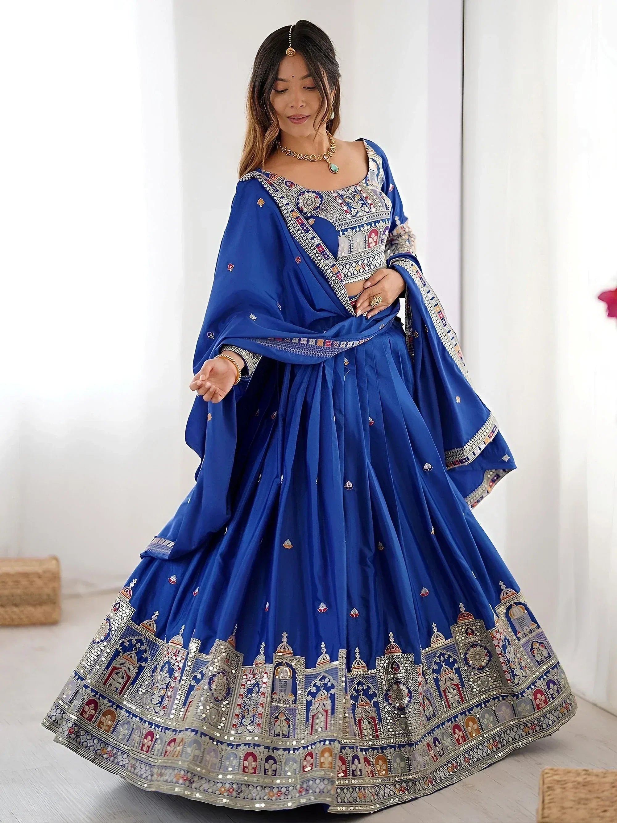 Royal blue designer lehenga choli with intricate mirror and embroidery work, perfect for Indian weddings and festive occasions.