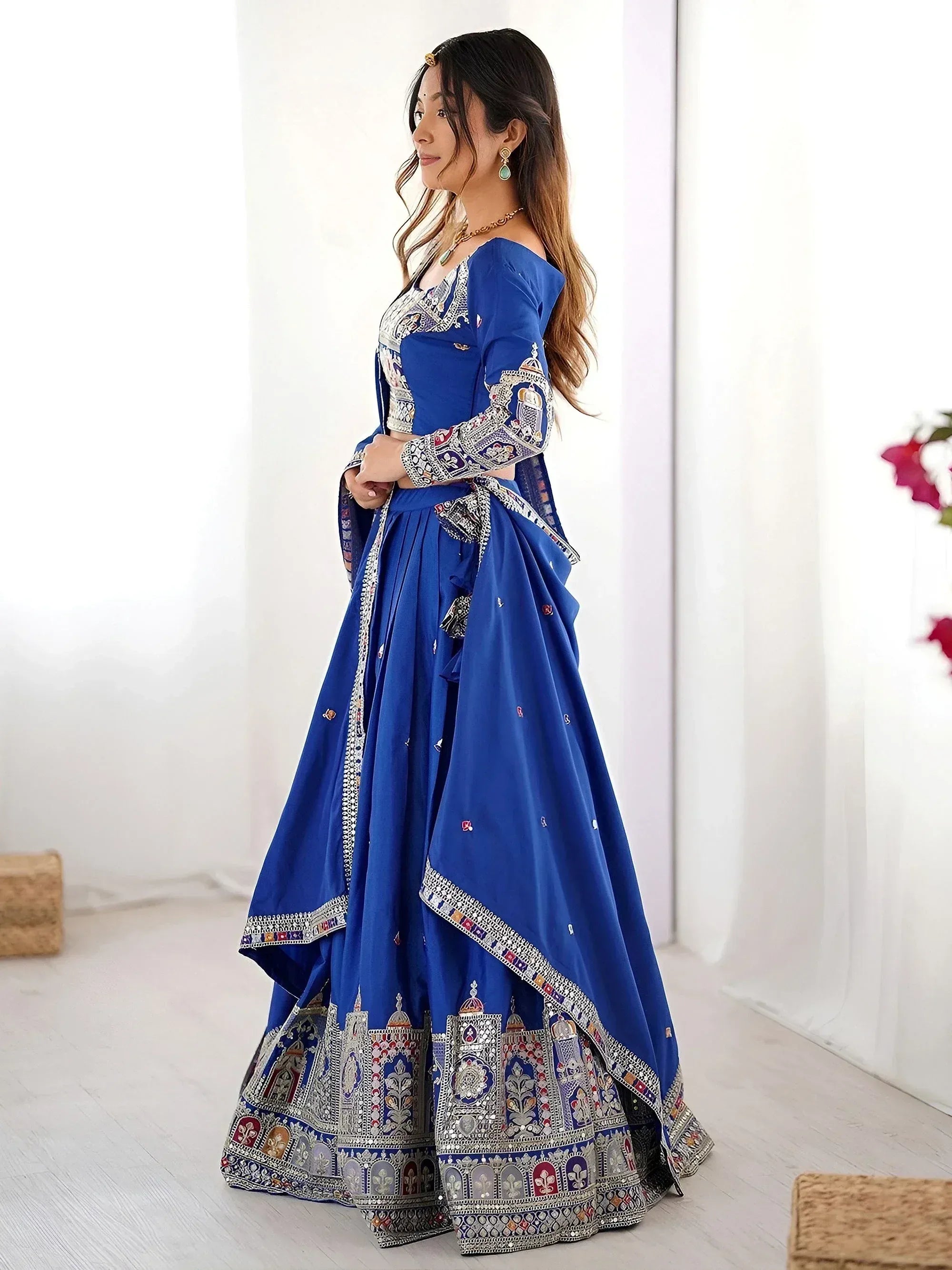 Royal blue designer lehenga choli with intricate embroidery and mirror work, perfect for Indian ethnic occasions.