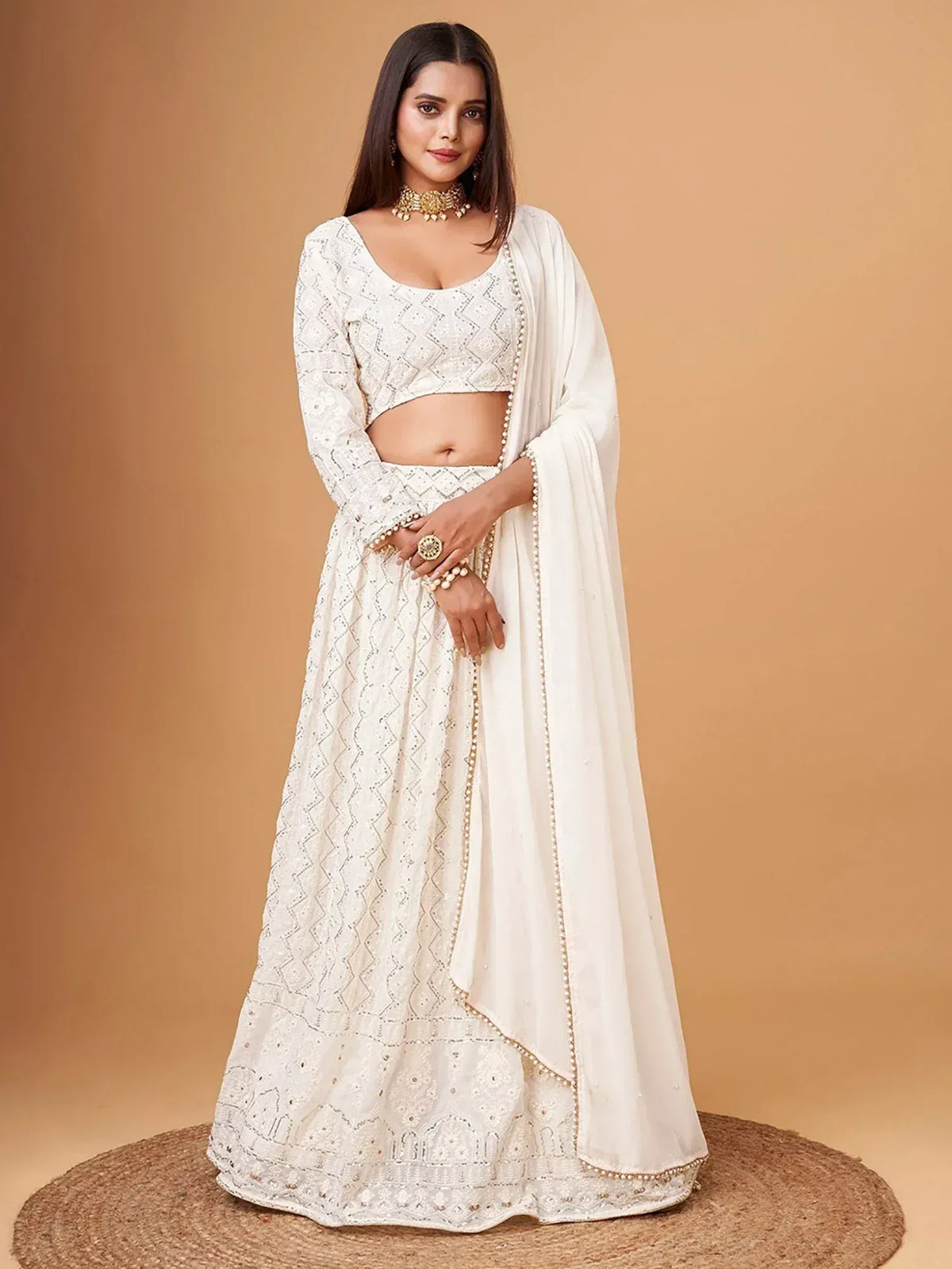 White embroidered lehenga choli with pearl detailing, perfect for Indian ethnic occasions and weddings.