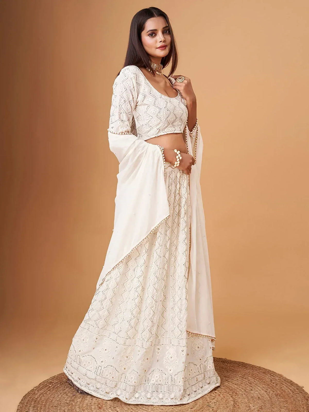 Elegant white embroidered lehenga choli with pearl detailing, perfect for Indian ethnic occasions