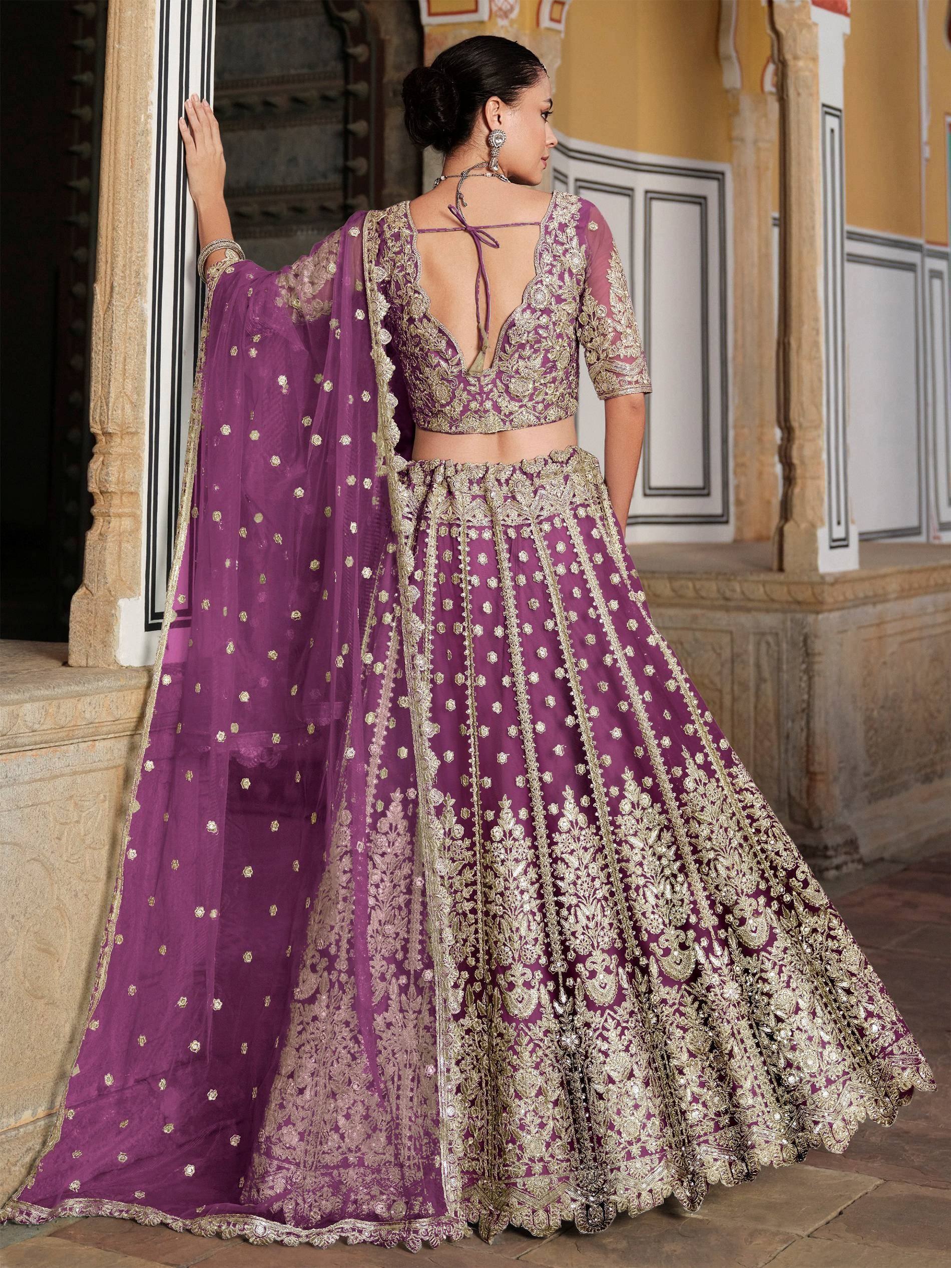 Purple and gold embroidered lehenga choli with sheer dupatta, perfect for Indian weddings and festive occasions.