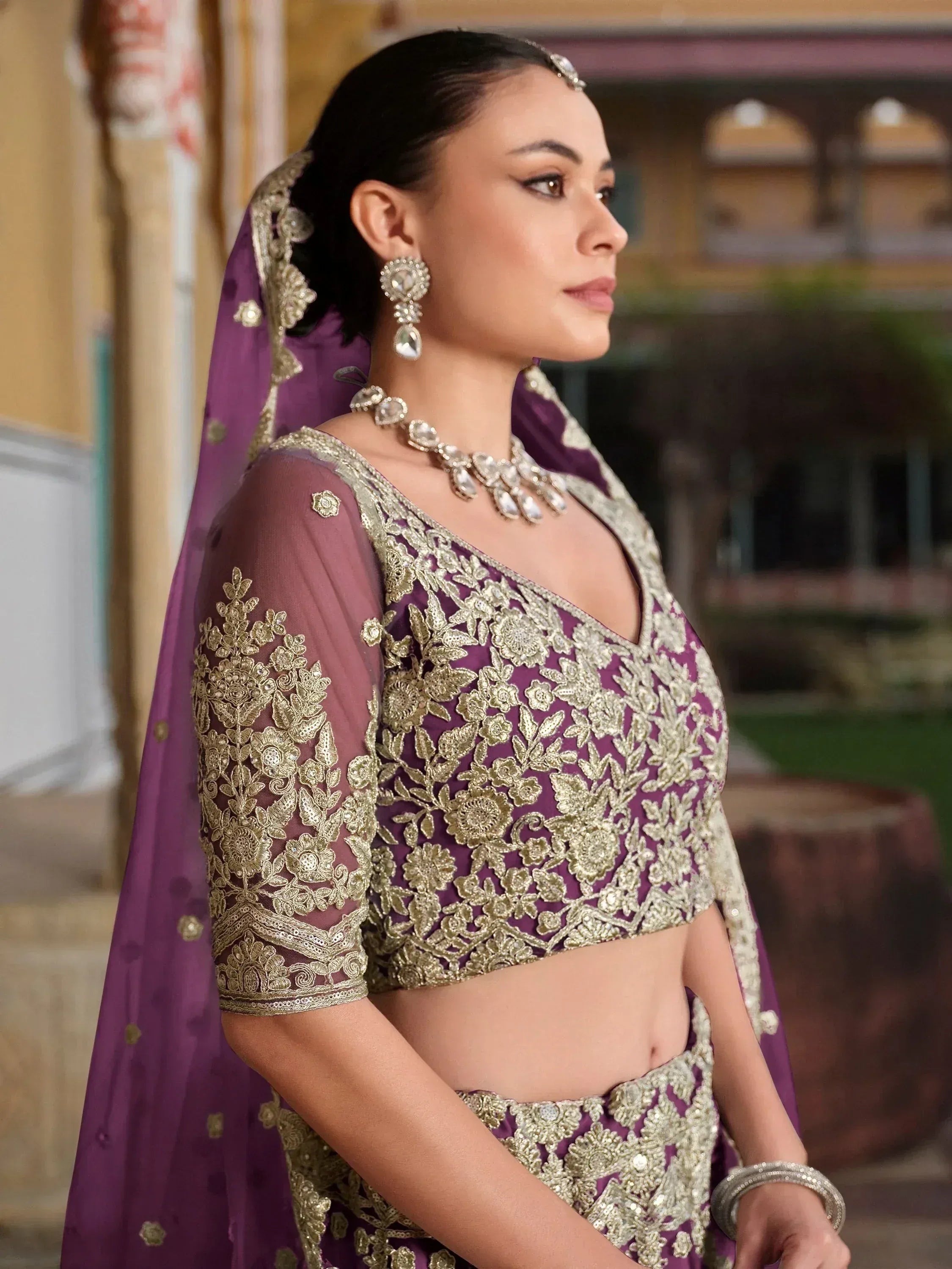 Purple and gold embroidered lehenga choli with matching dupatta, perfect for Indian weddings and festive occasions.