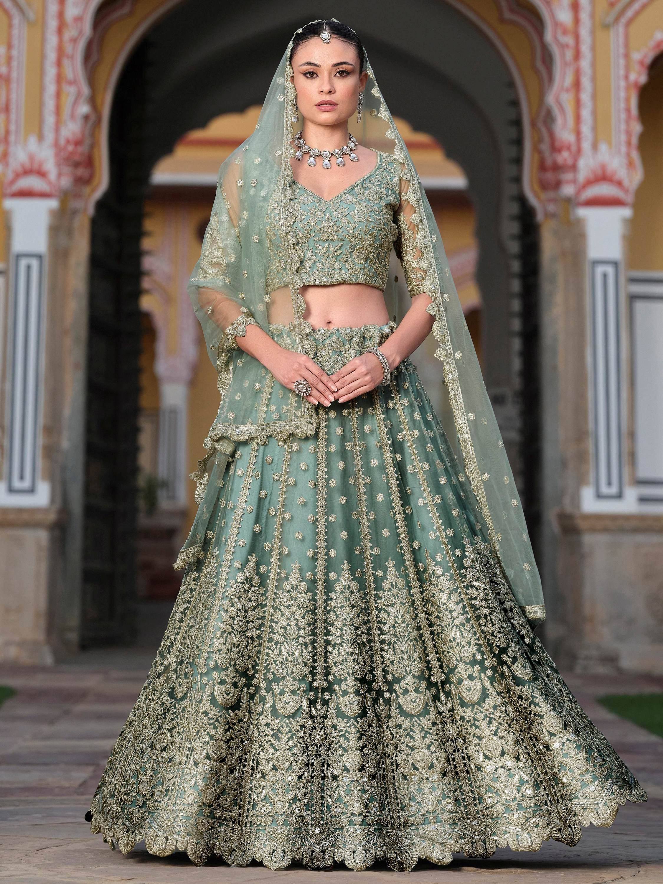 Elegant mint green lehenga choli with gold embroidery, perfect for Indian weddings and festive occasions.