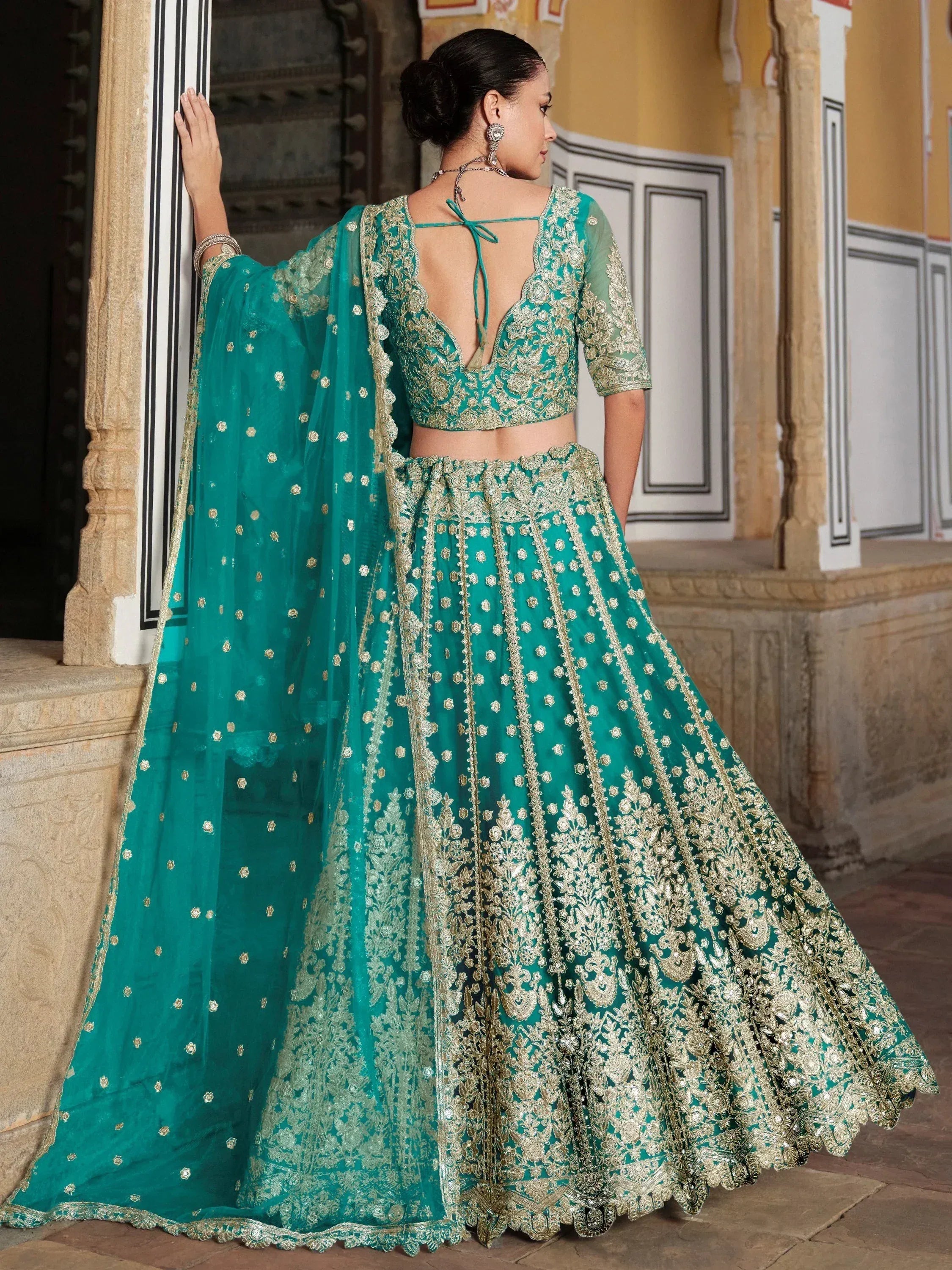 Teal designer lehenga choli with gold embroidery, back view, ethnic Indian wear