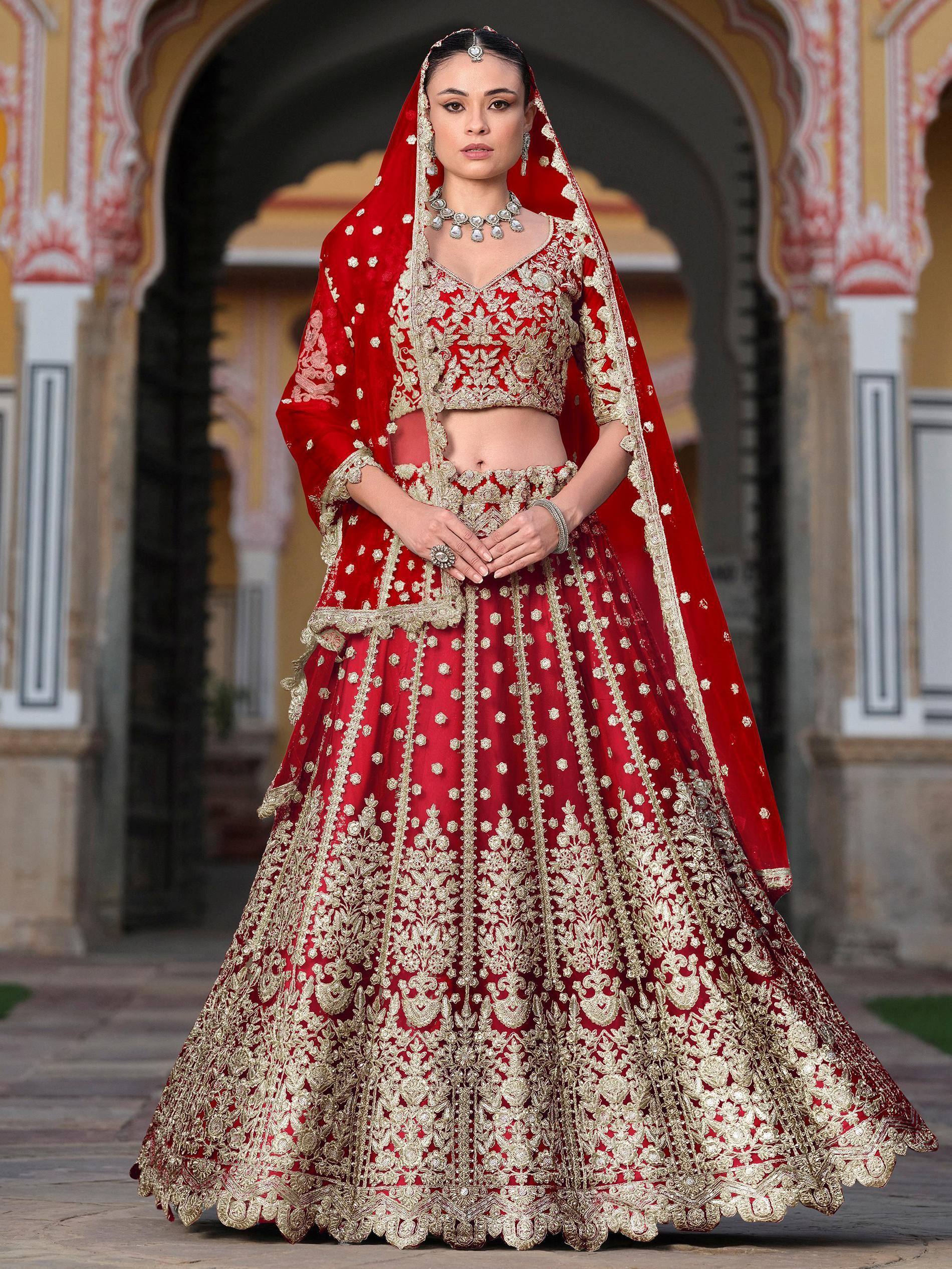 Red and gold embroidered lehenga choli with dupatta, traditional Indian bridal wear