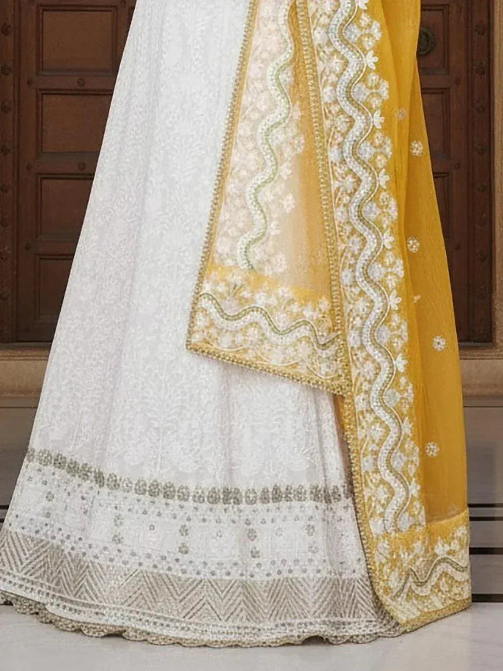 White embroidered lehenga with yellow dupatta, ethnic Indian wear for weddings and festivals