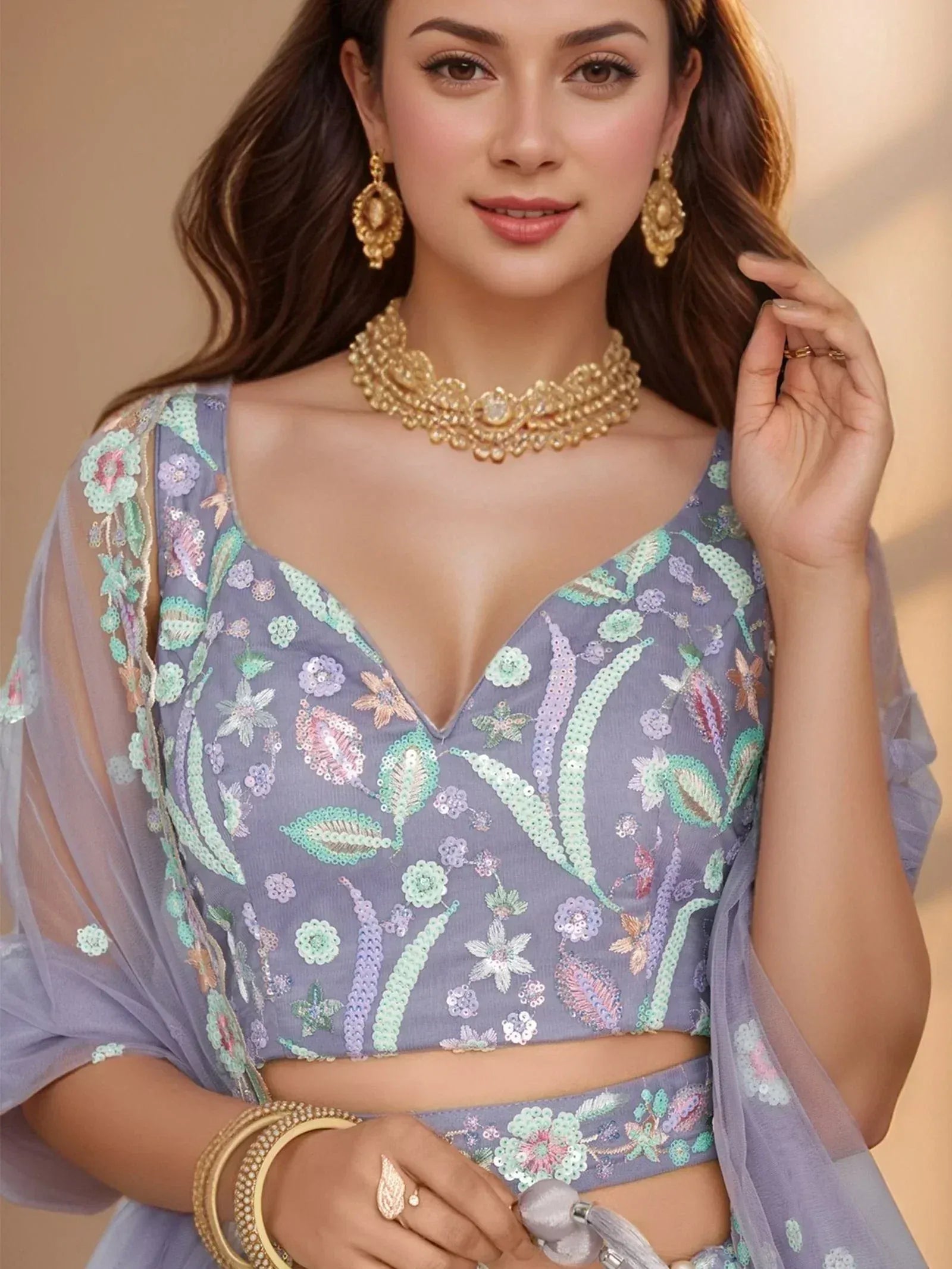 Elegant lavender ethnic crop top with floral sequin embroidery, paired with matching skirt and gold jewelry.