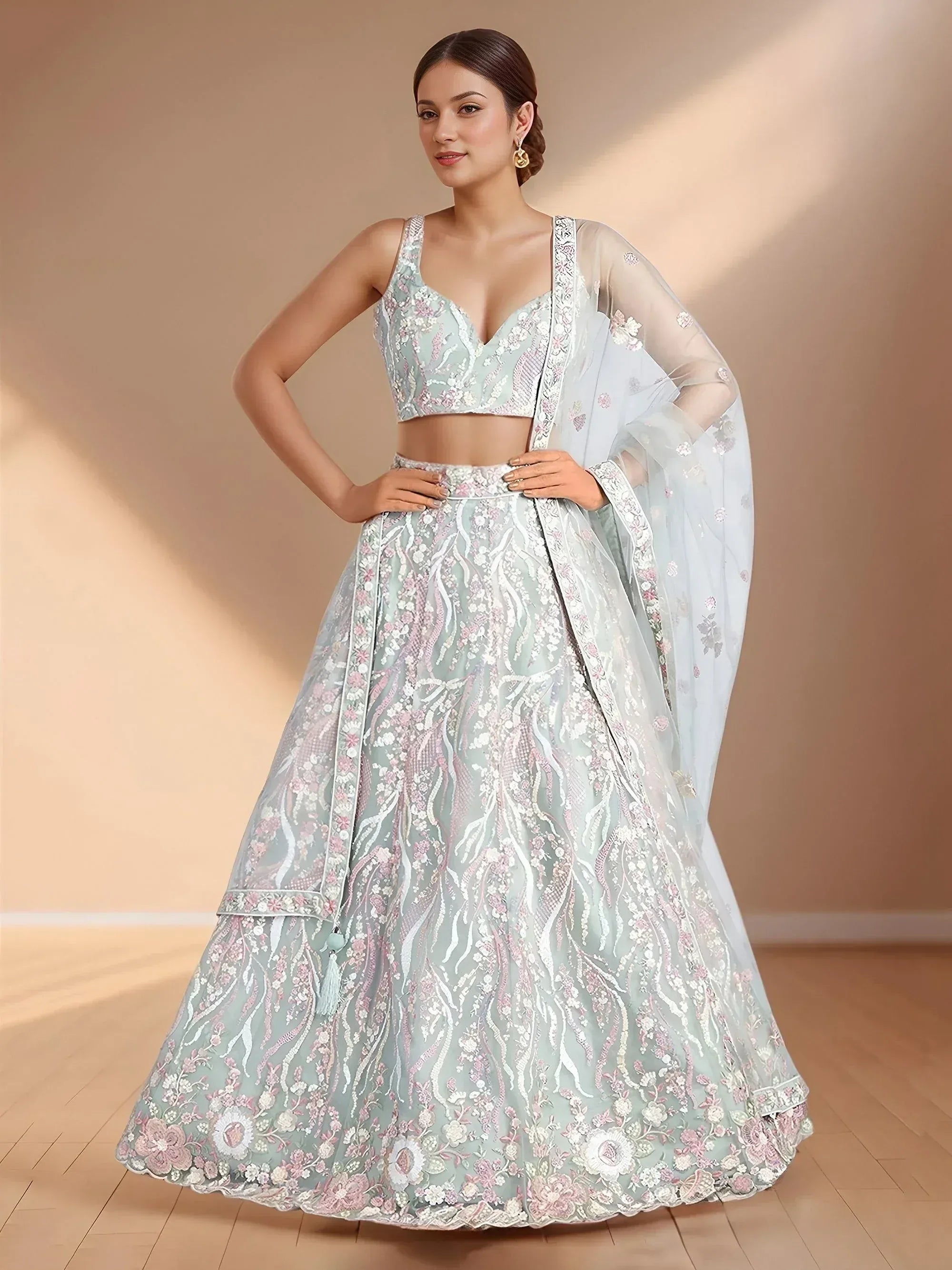 Mint green floral embroidered lehenga choli with sheer dupatta, perfect for Indian weddings and festive occasions.