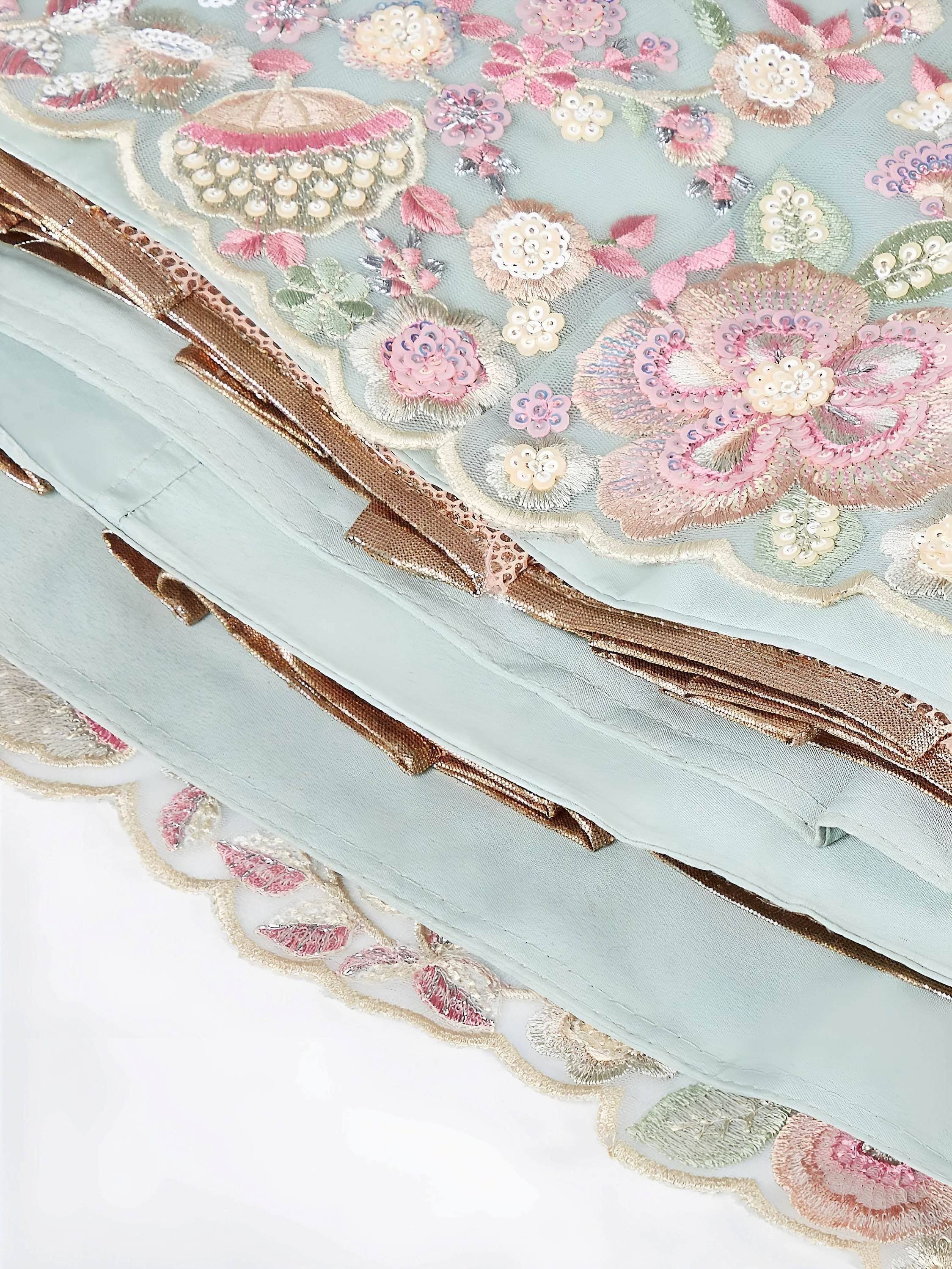 Pastel blue lehenga with floral embroidery, sequins, and gold trim for Indian ethnic wear