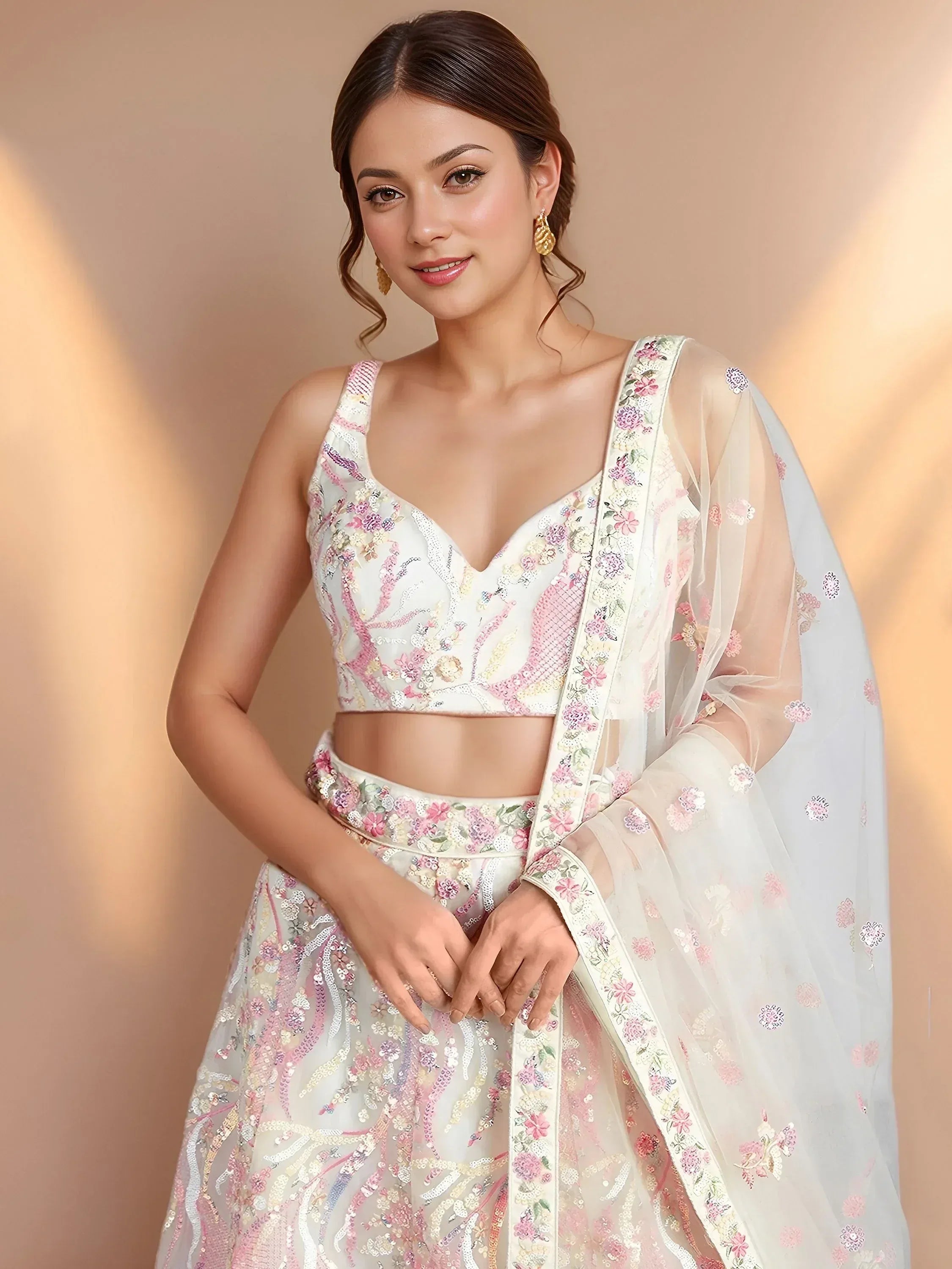 Elegant white lehenga choli with pink floral embroidery and sheer dupatta for Indian ethnic wear