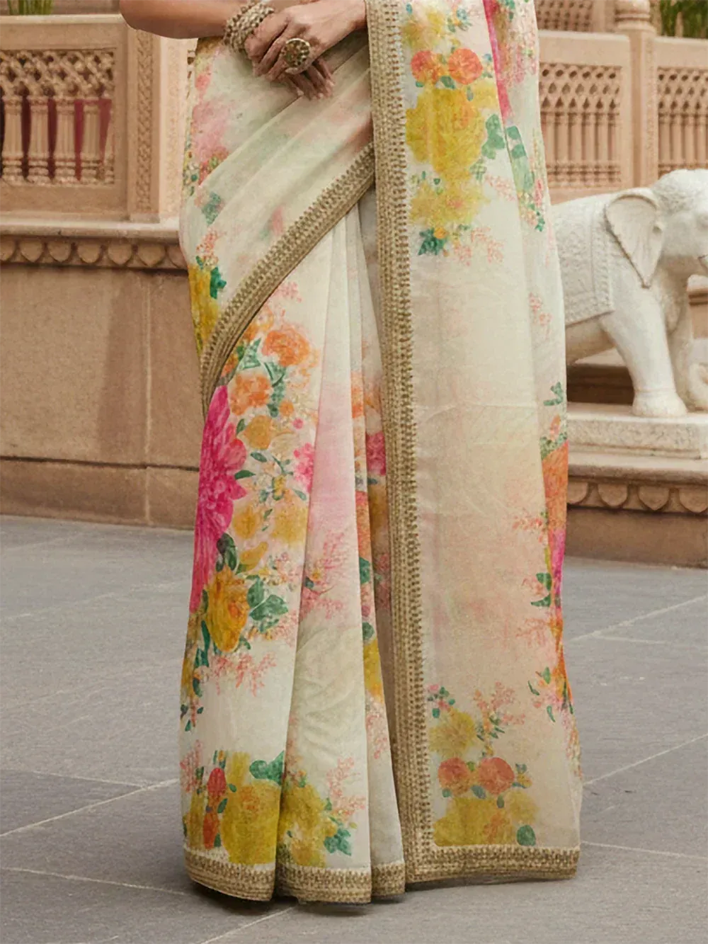 Floral printed Indian saree with gold border, styled for ethnic occasions