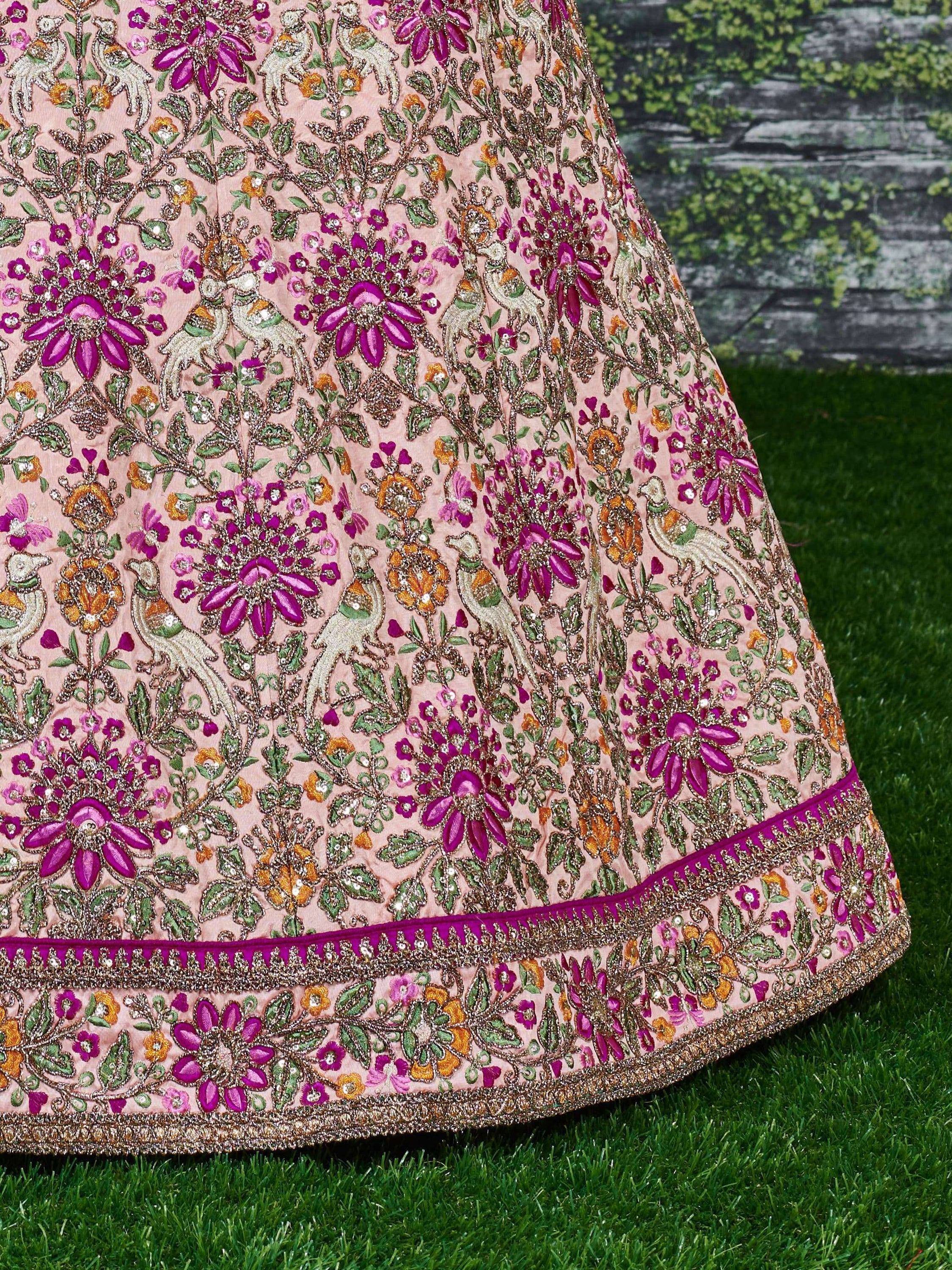 Pink embroidered lehenga with floral and bird motifs, perfect for Indian ethnic wear occasions.