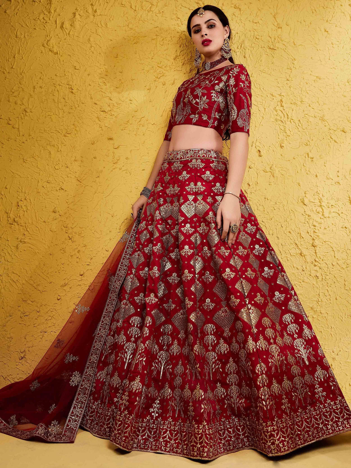 Red and gold embroidered lehenga choli with intricate floral patterns, perfect for Indian ethnic wear.