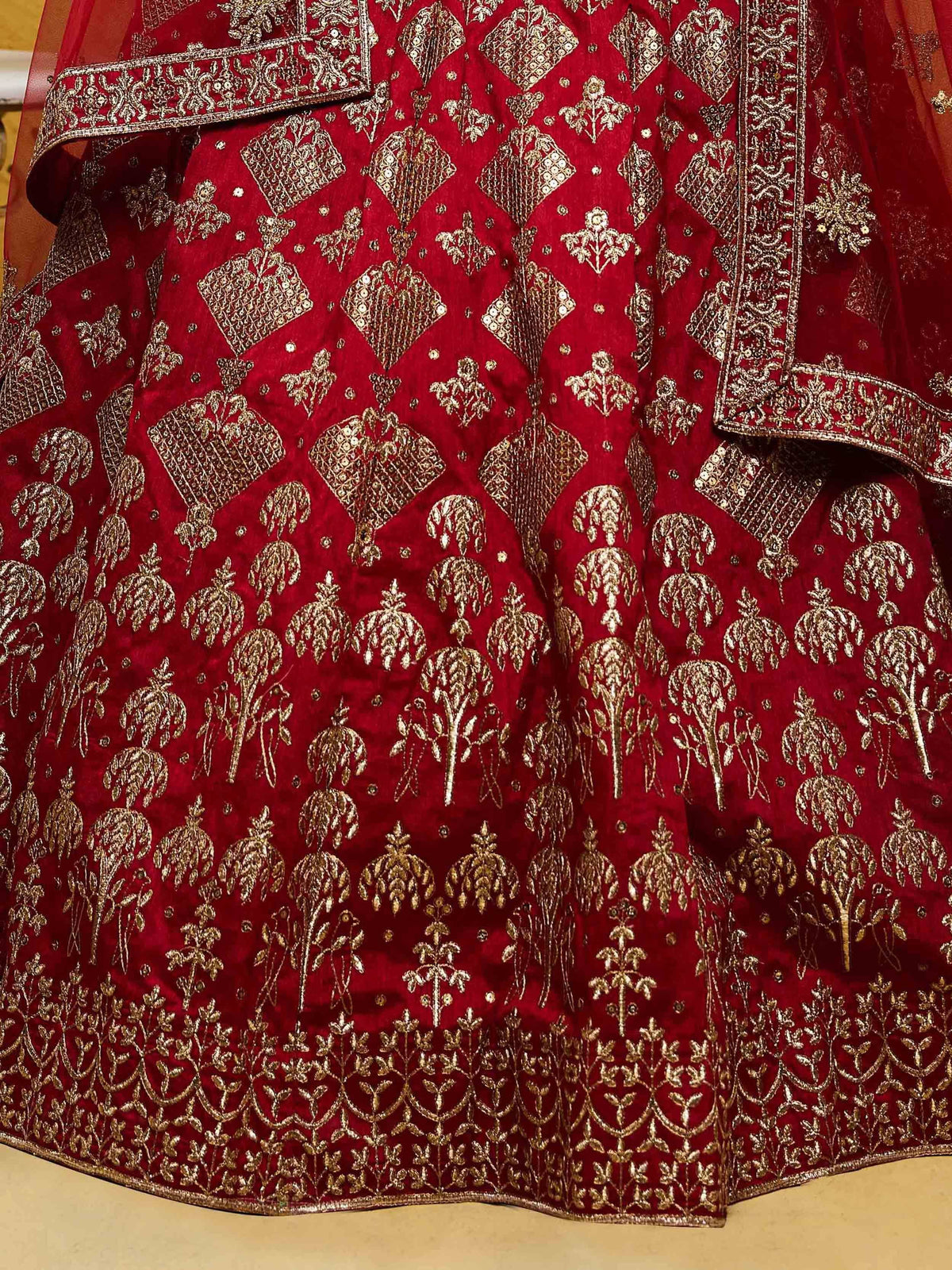Red velvet lehenga with gold floral embroidery and intricate border design