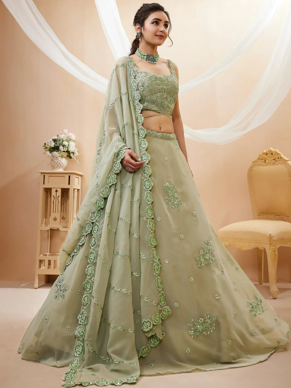 Elegant sage green lehenga choli with floral embroidery, perfect for Indian ethnic wear and festive occasions.