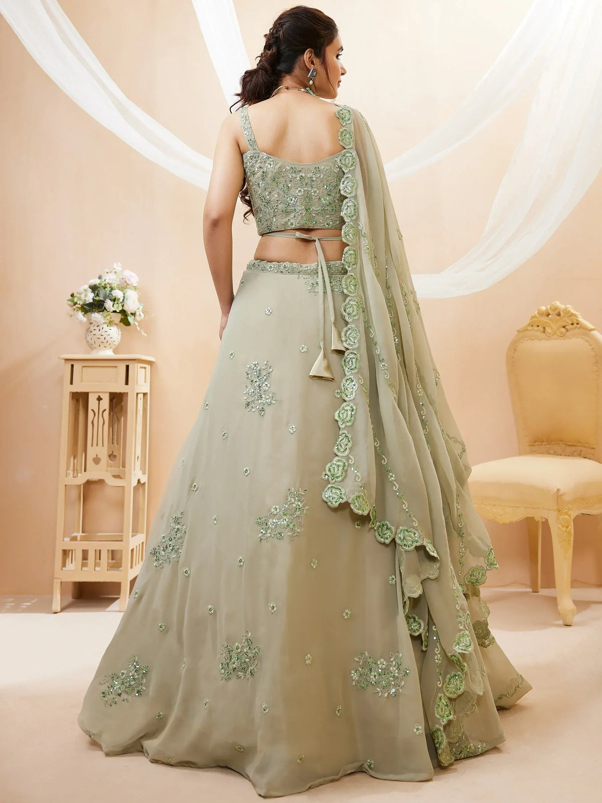 Elegant green embroidered lehenga choli with floral detailing and sheer dupatta for Indian ethnic wear