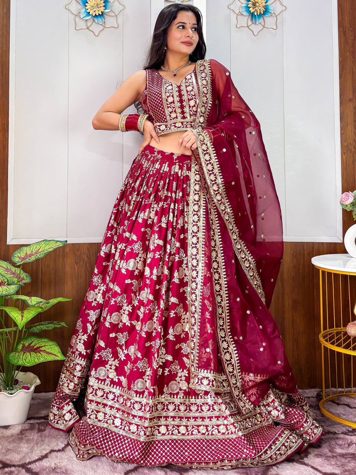 Maroon designer lehenga choli with gold floral embroidery, perfect for Indian weddings and festive occasions