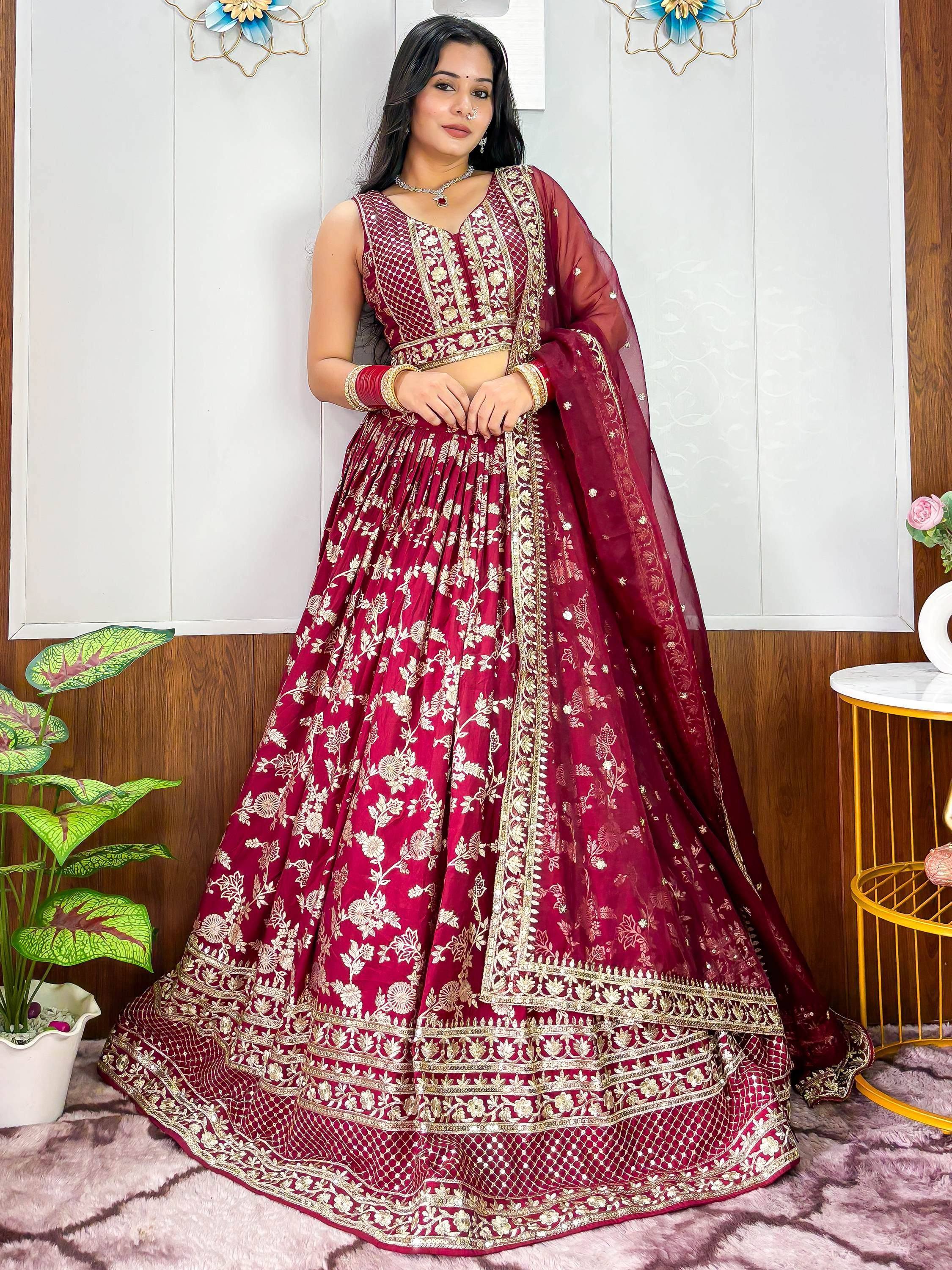Maroon designer lehenga choli with gold floral embroidery, perfect for Indian weddings and festive occasions.